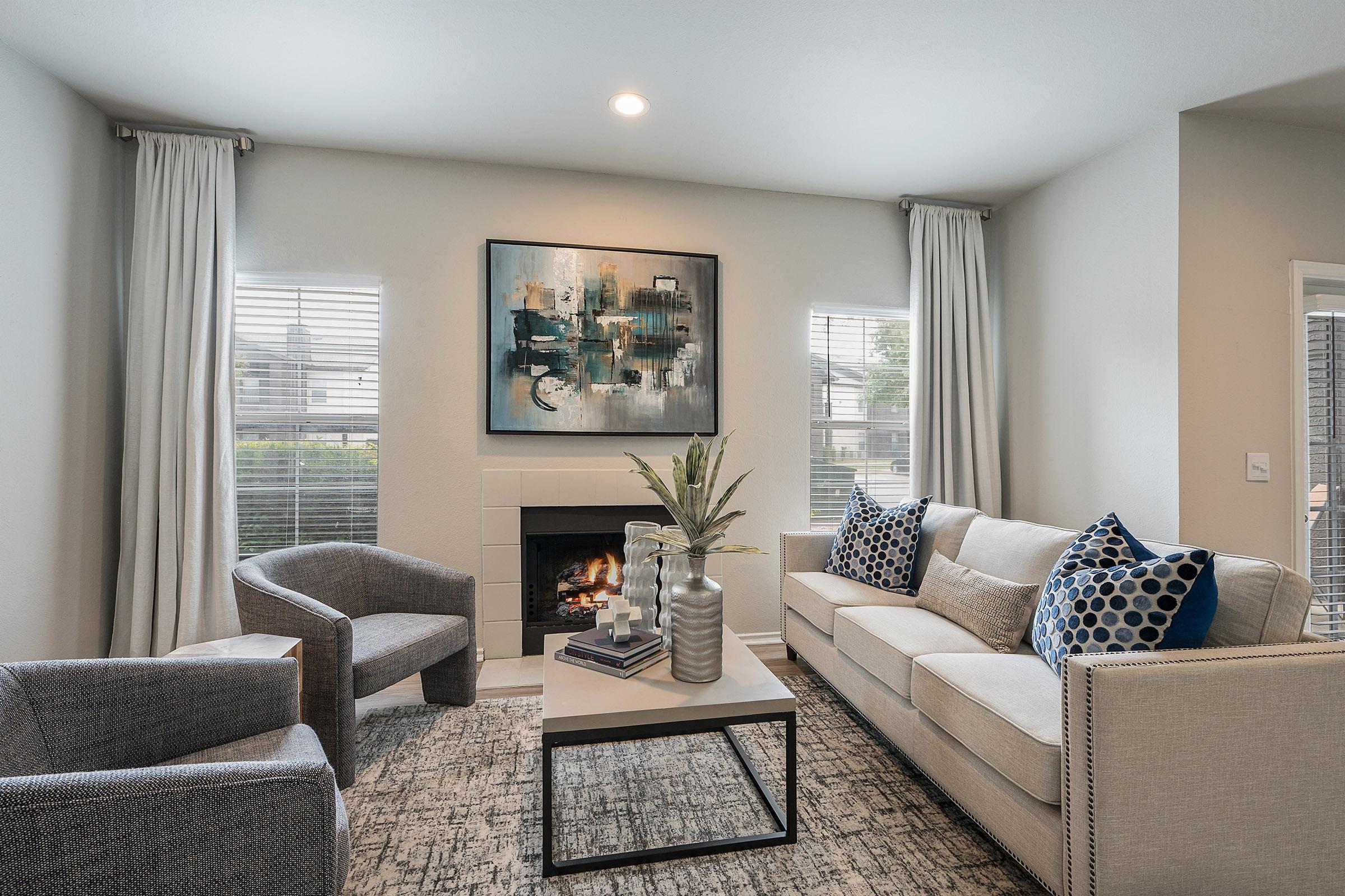 a living room filled with furniture and a large window