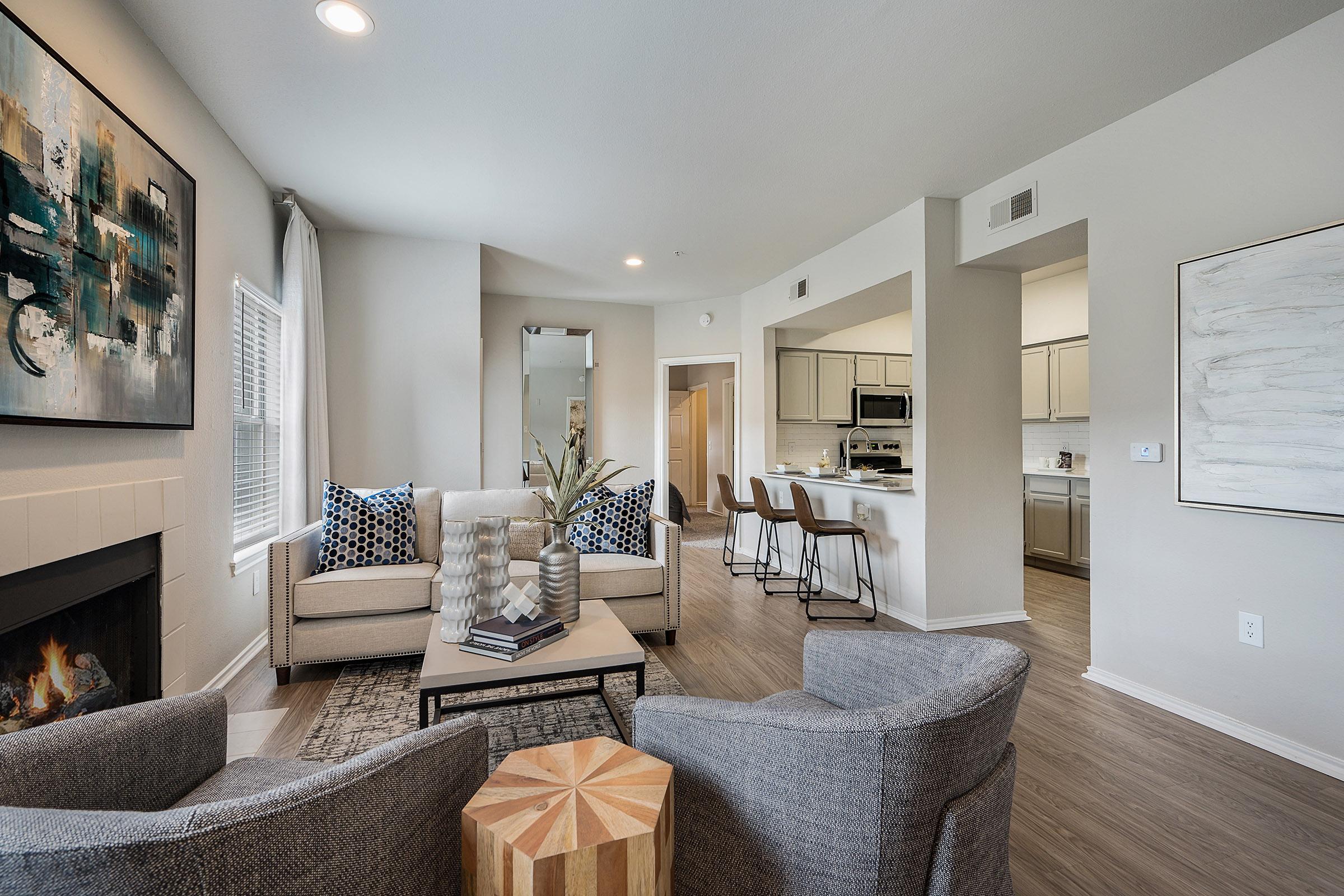 a living room filled with furniture and a fireplace