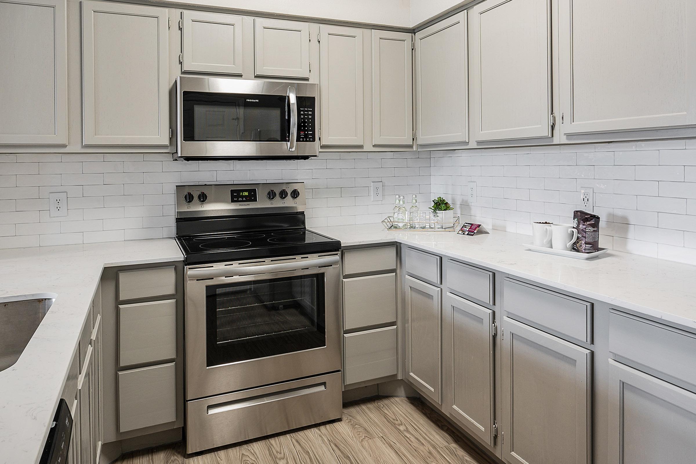 a stove top oven sitting inside of a kitchen