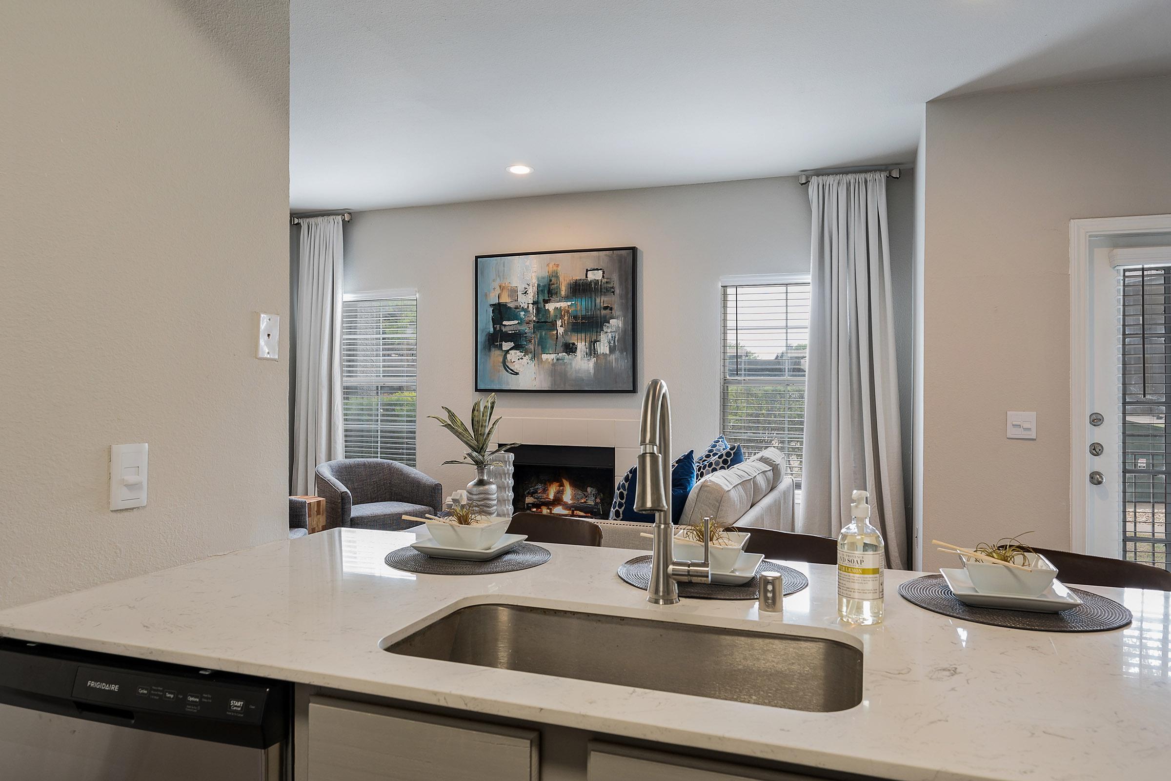 a kitchen with a sink and a mirror