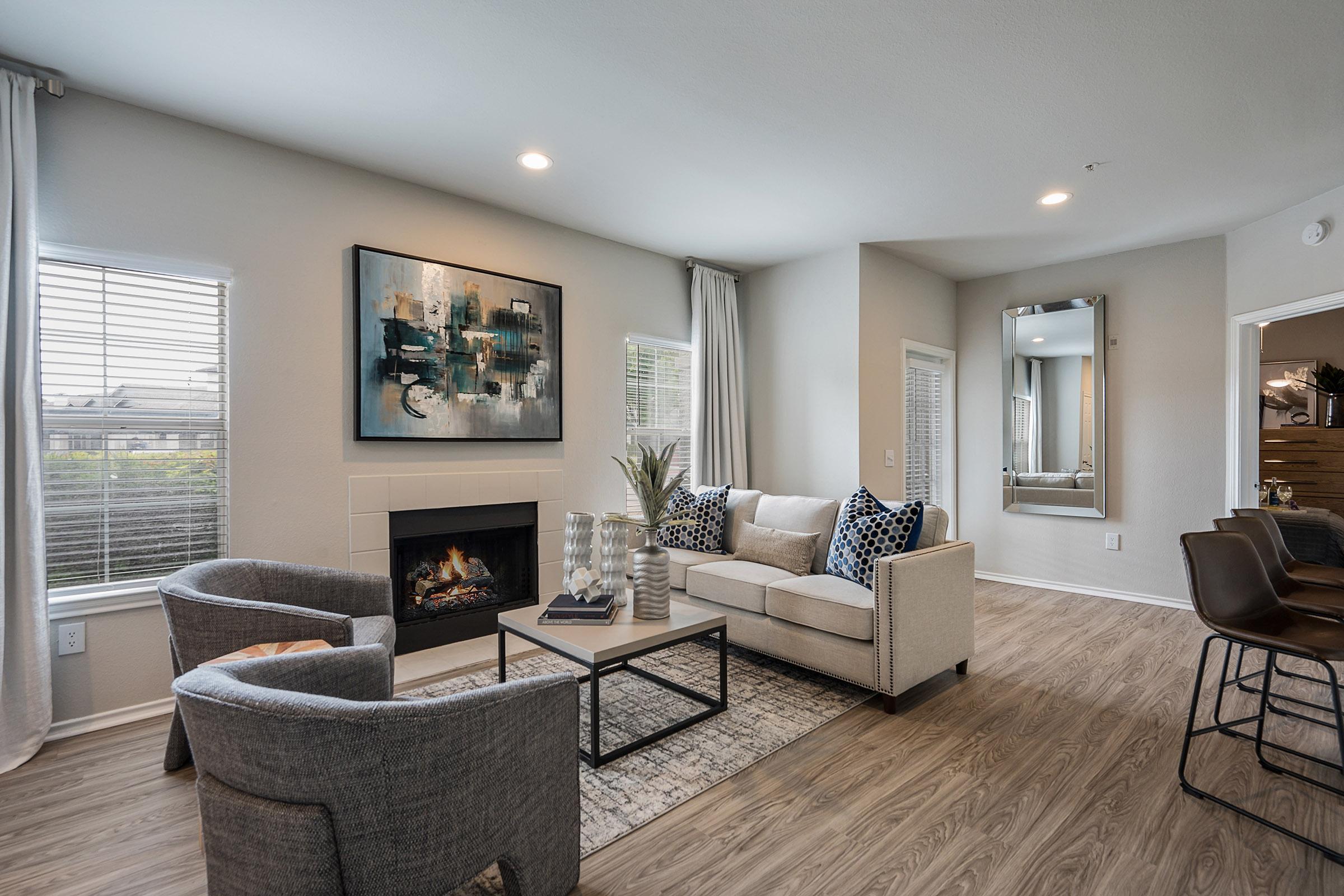 a living room filled with furniture and a large window