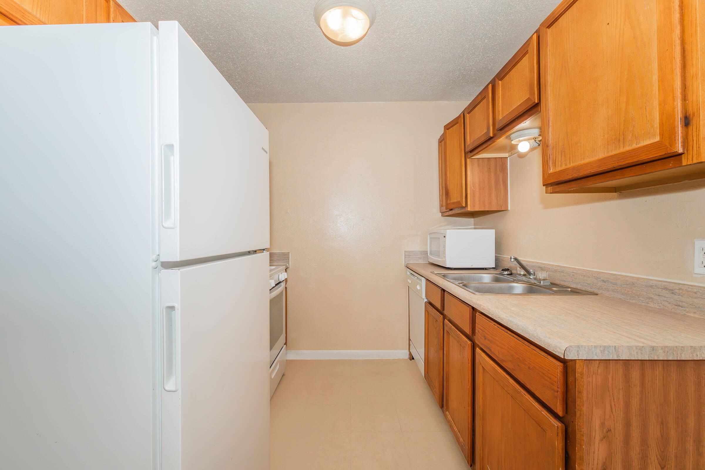 a kitchen with a sink and a refrigerator