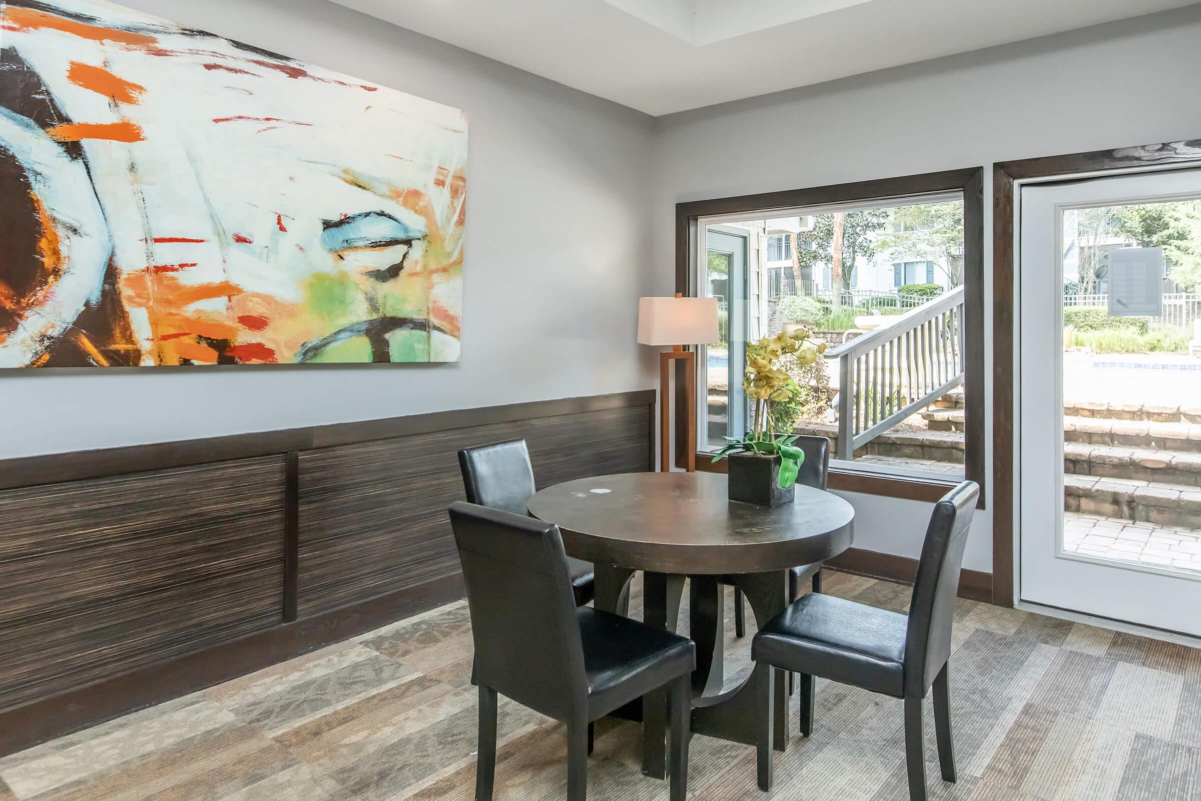 a dining room table in front of a window