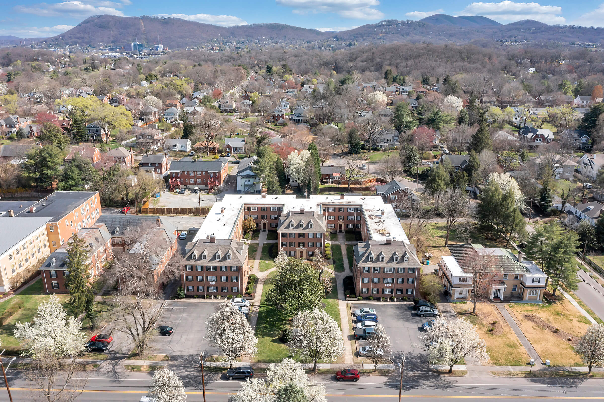 a large building with a mountain in the background