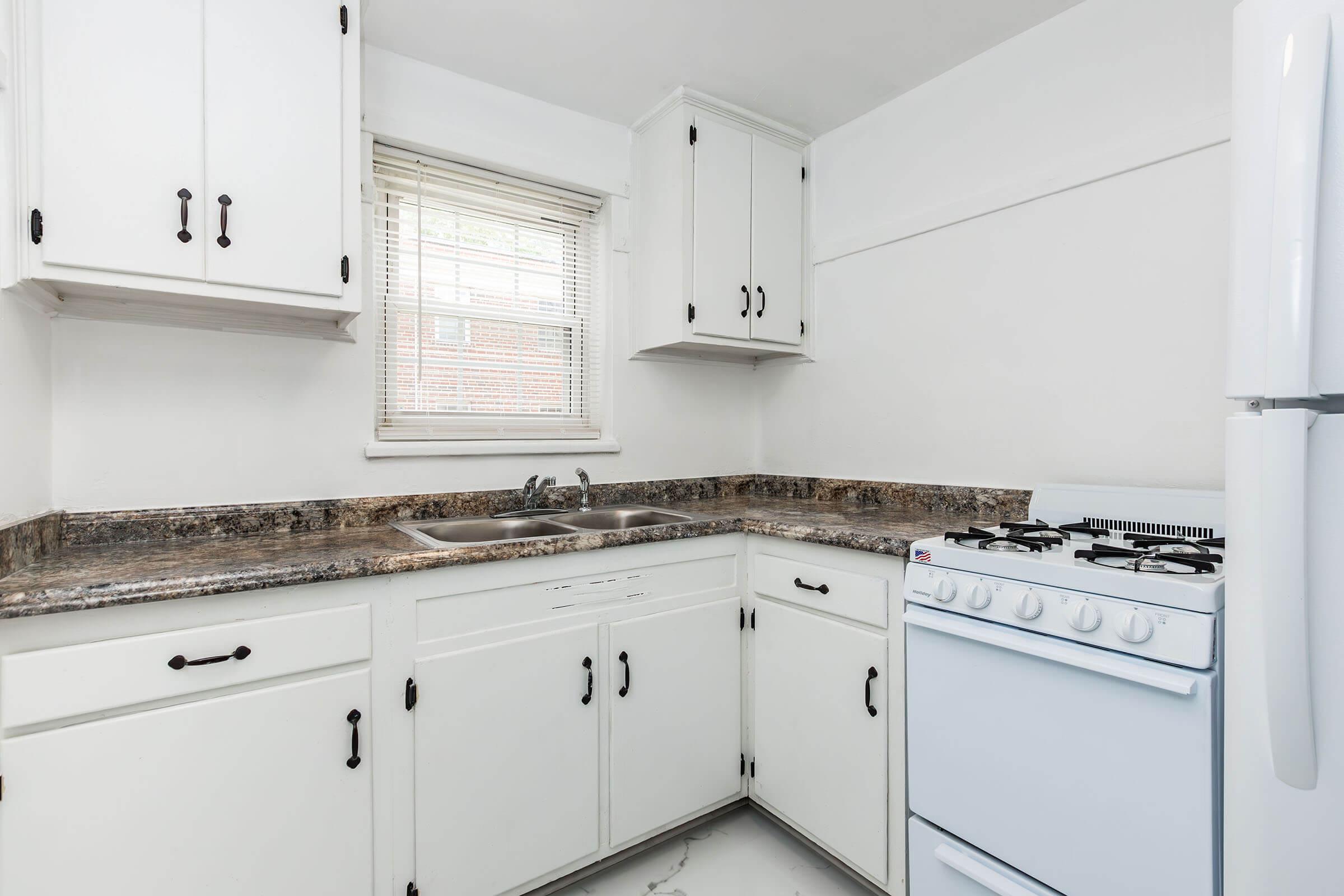 a kitchen with a stove and a refrigerator