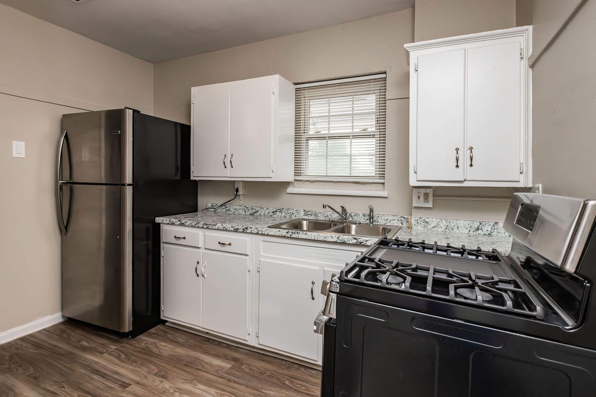 a kitchen with a stove and a refrigerator