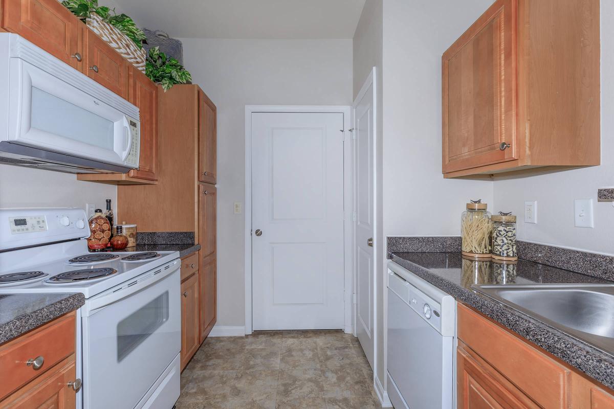 a kitchen with a stove sink and refrigerator
