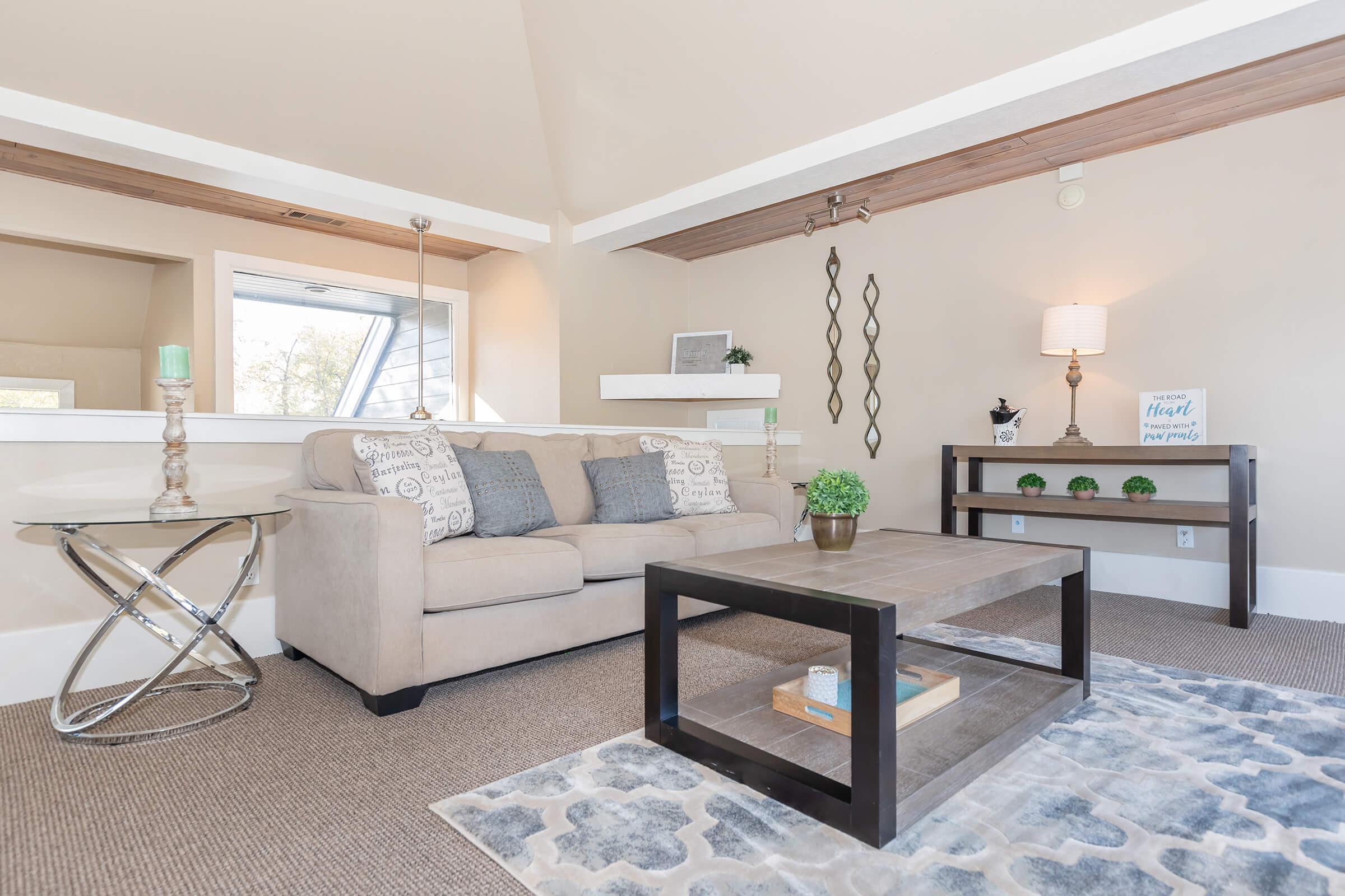 a living room filled with furniture and a large window