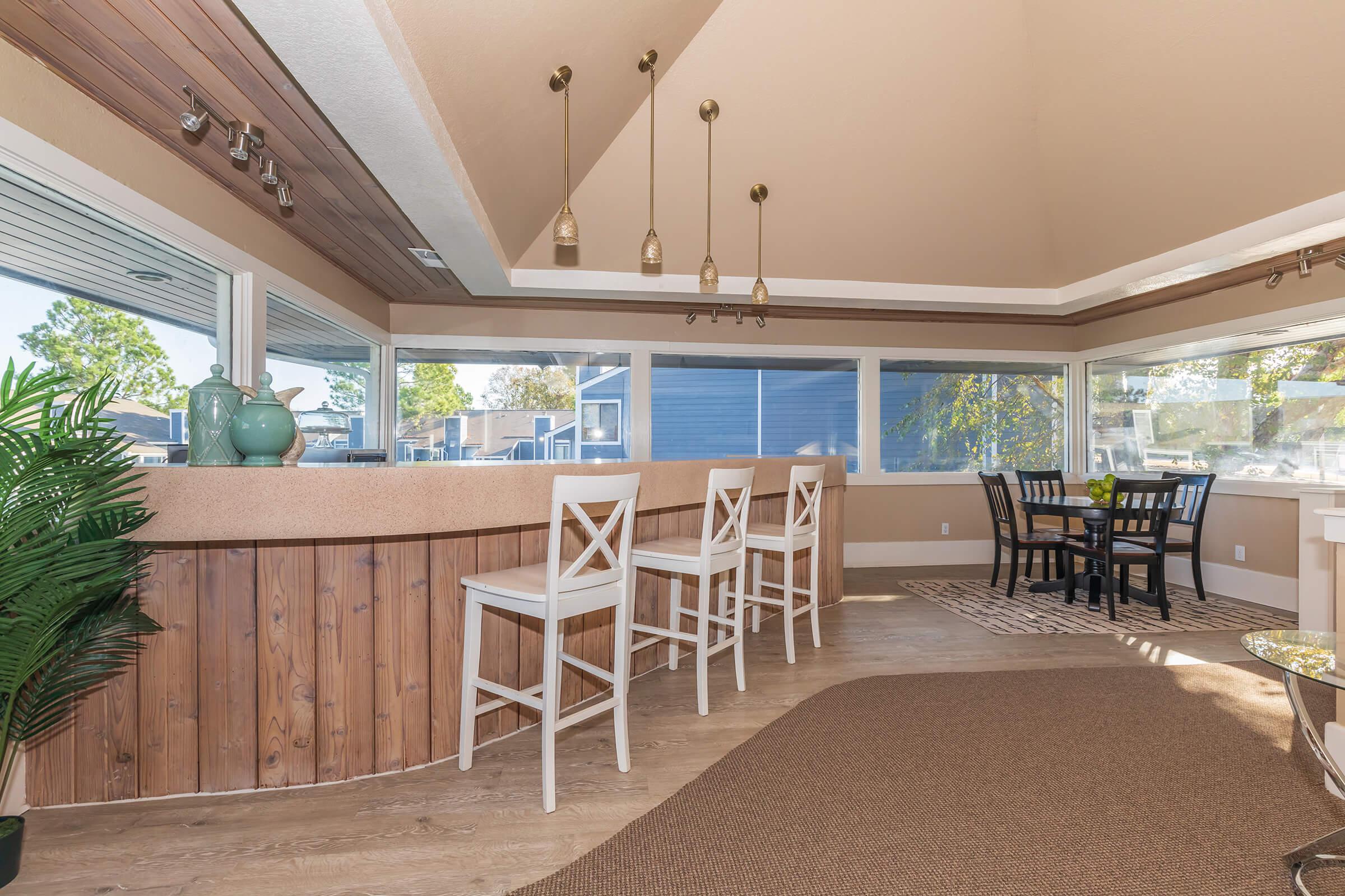 a dining room table in front of a fence