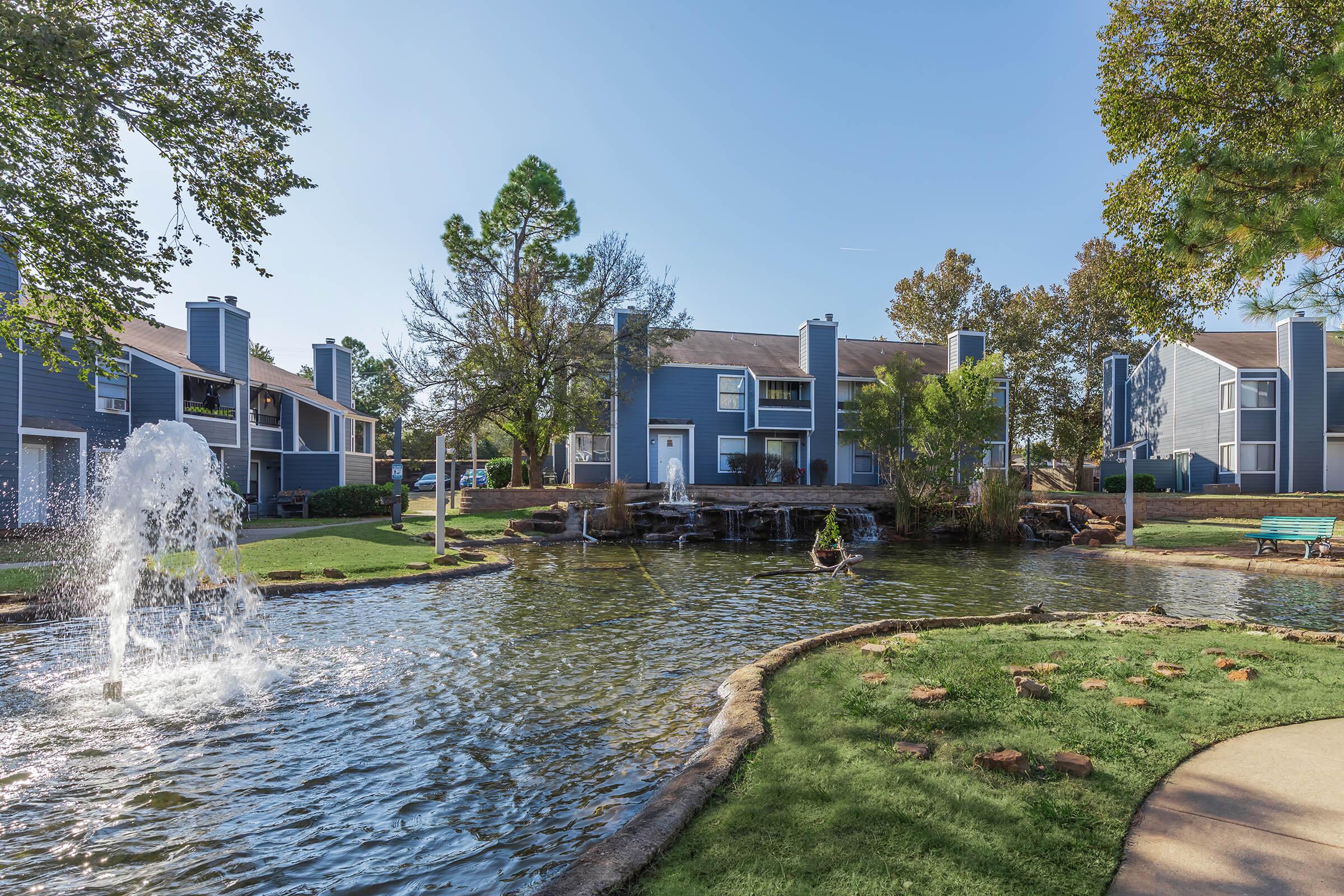 a garden with water in the background