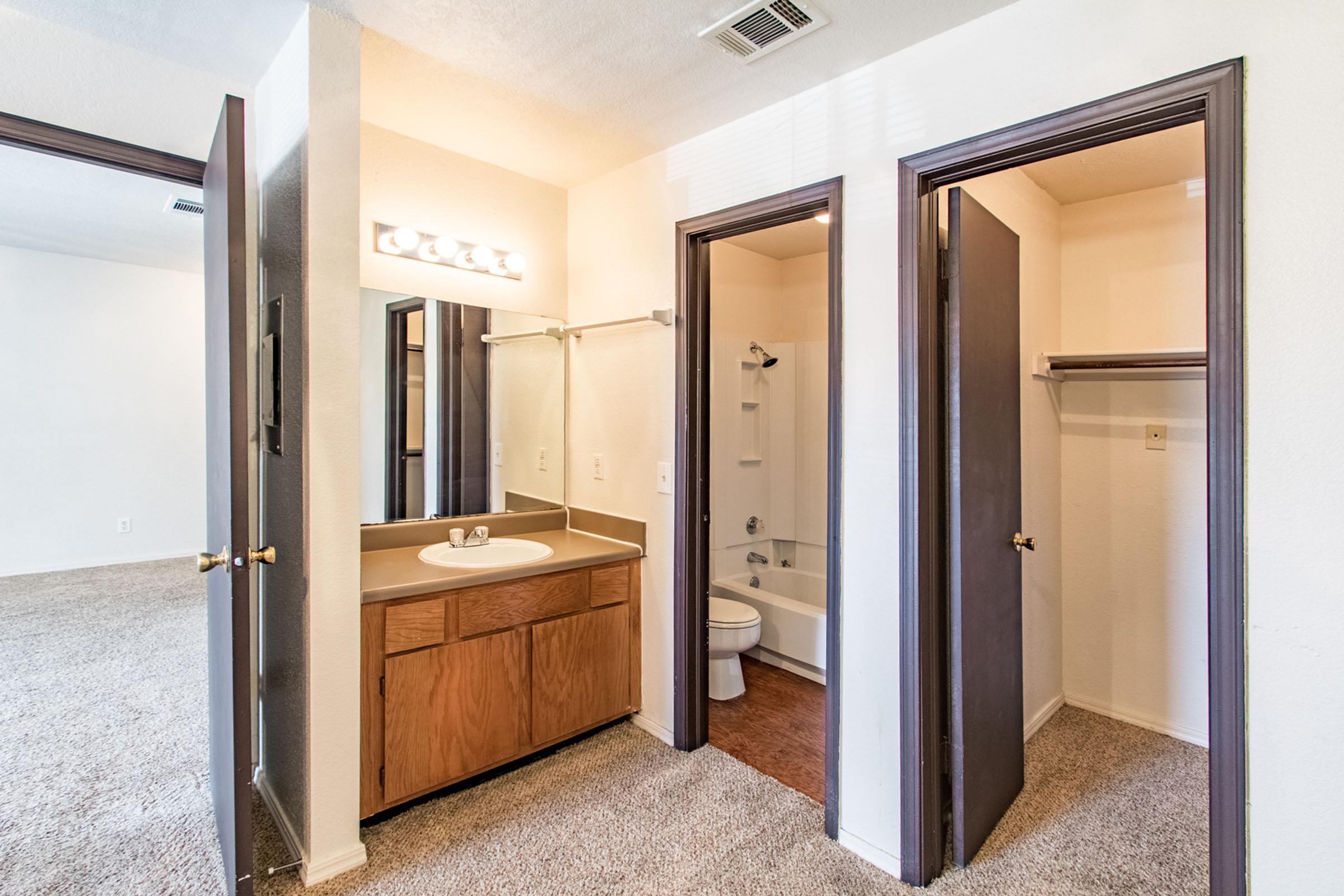 a double door in a room with a sink and a mirror