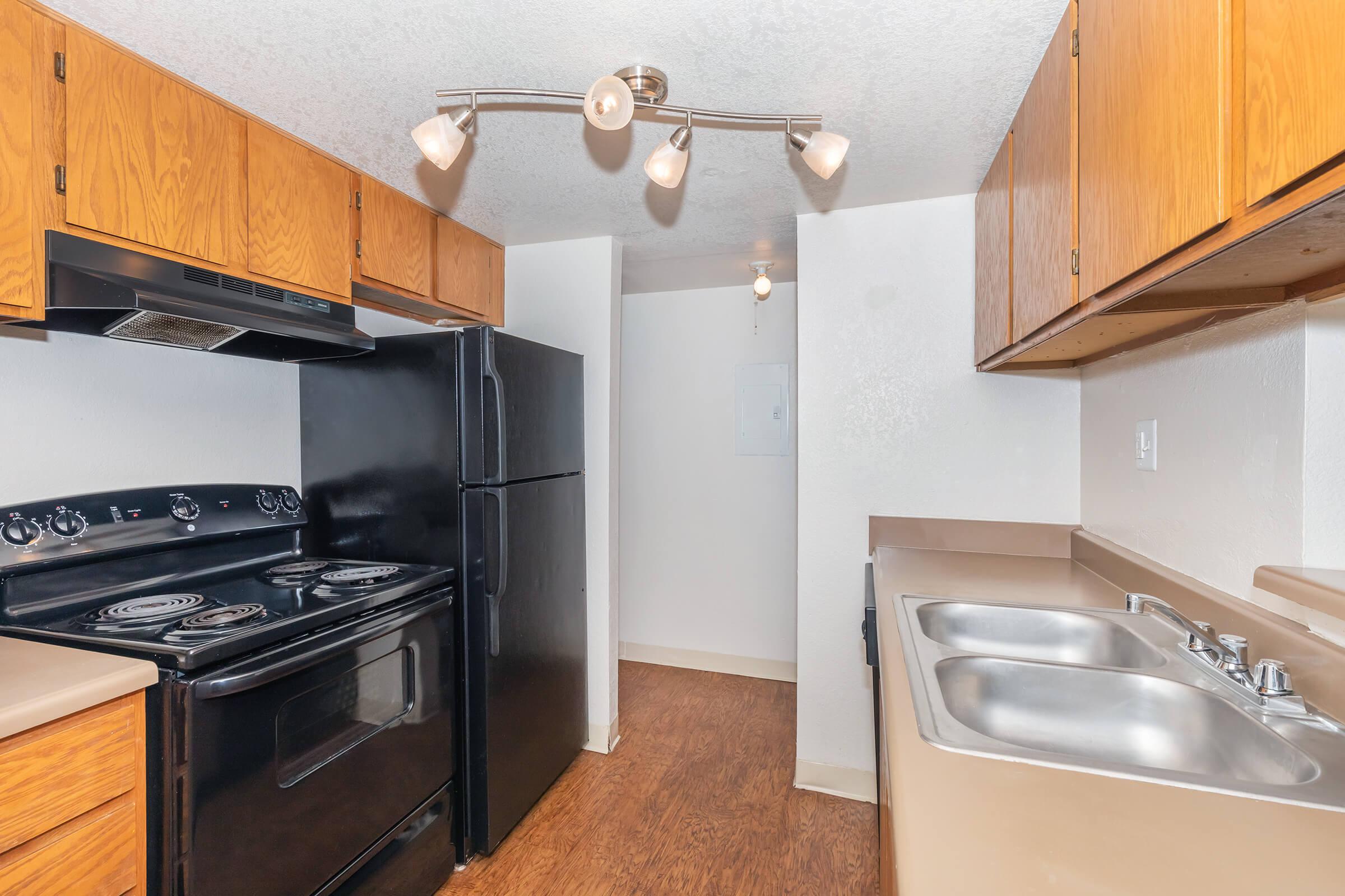 a stove top oven sitting inside of a kitchen