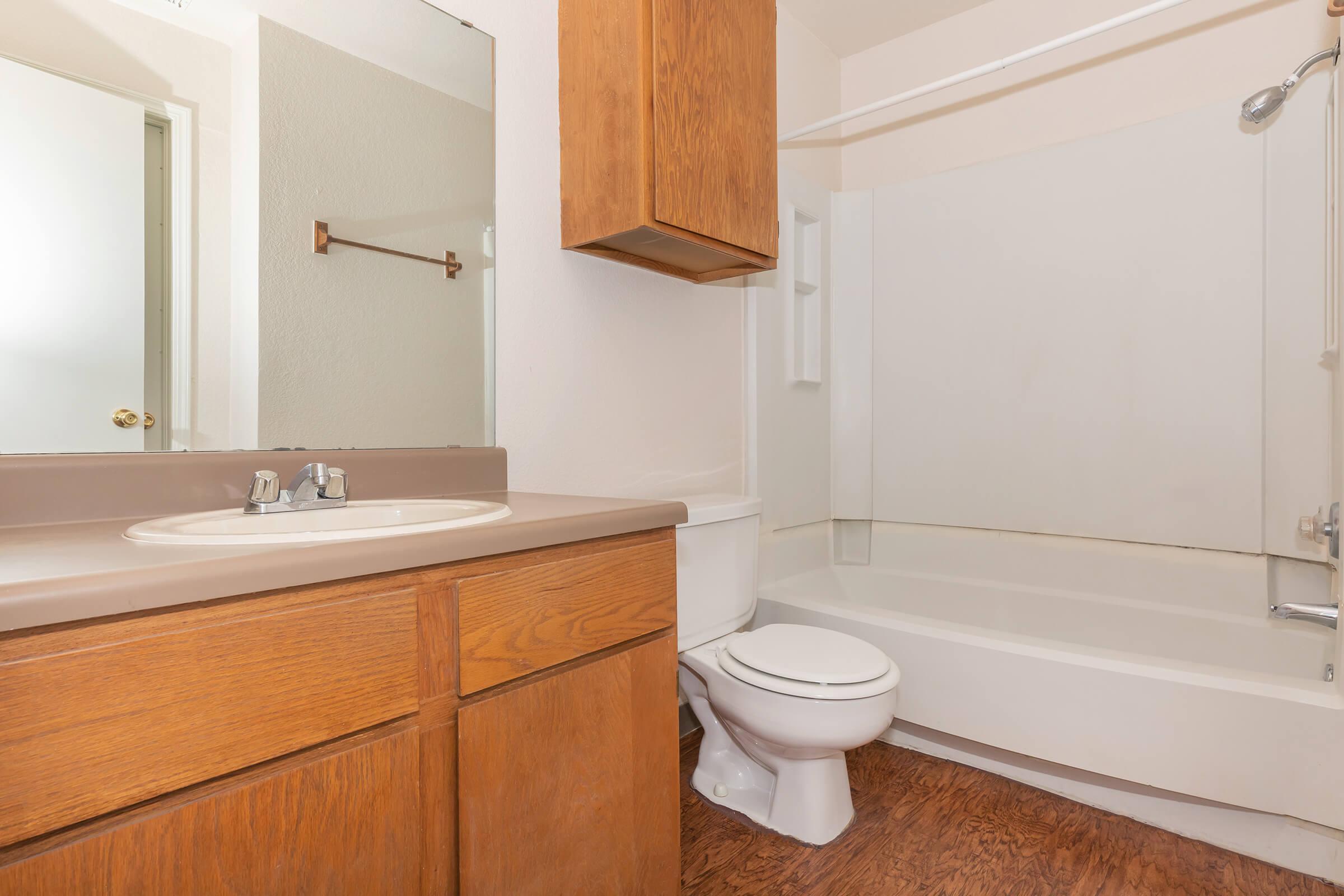 a white tub sitting next to a sink