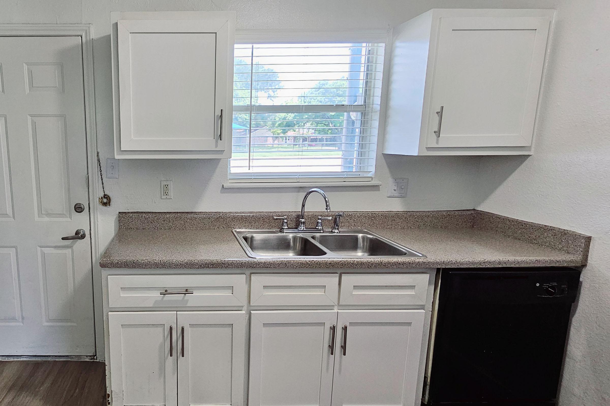 a stove top oven sitting inside of a kitchen