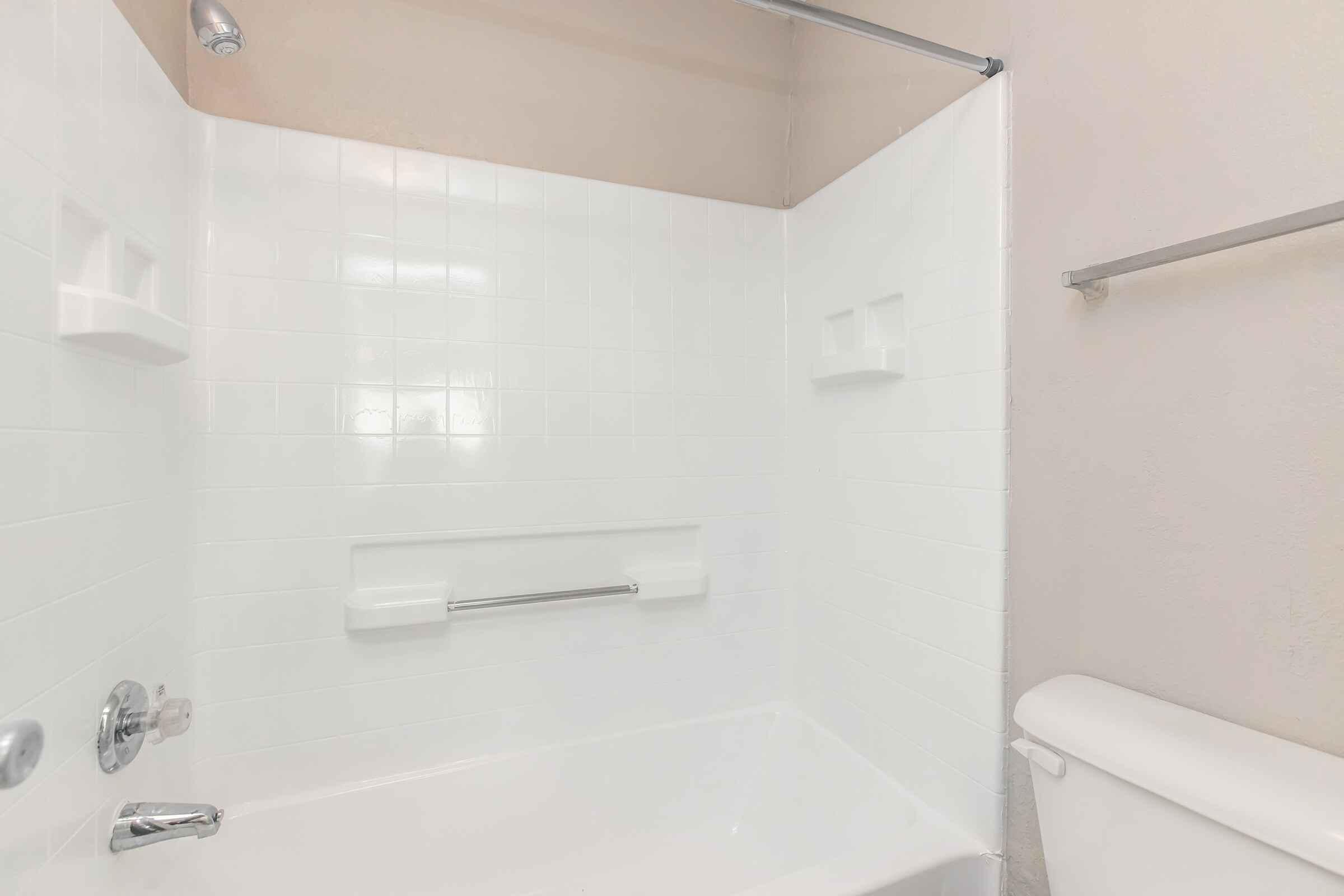 a room with a sink and a white tub sitting next to a shower