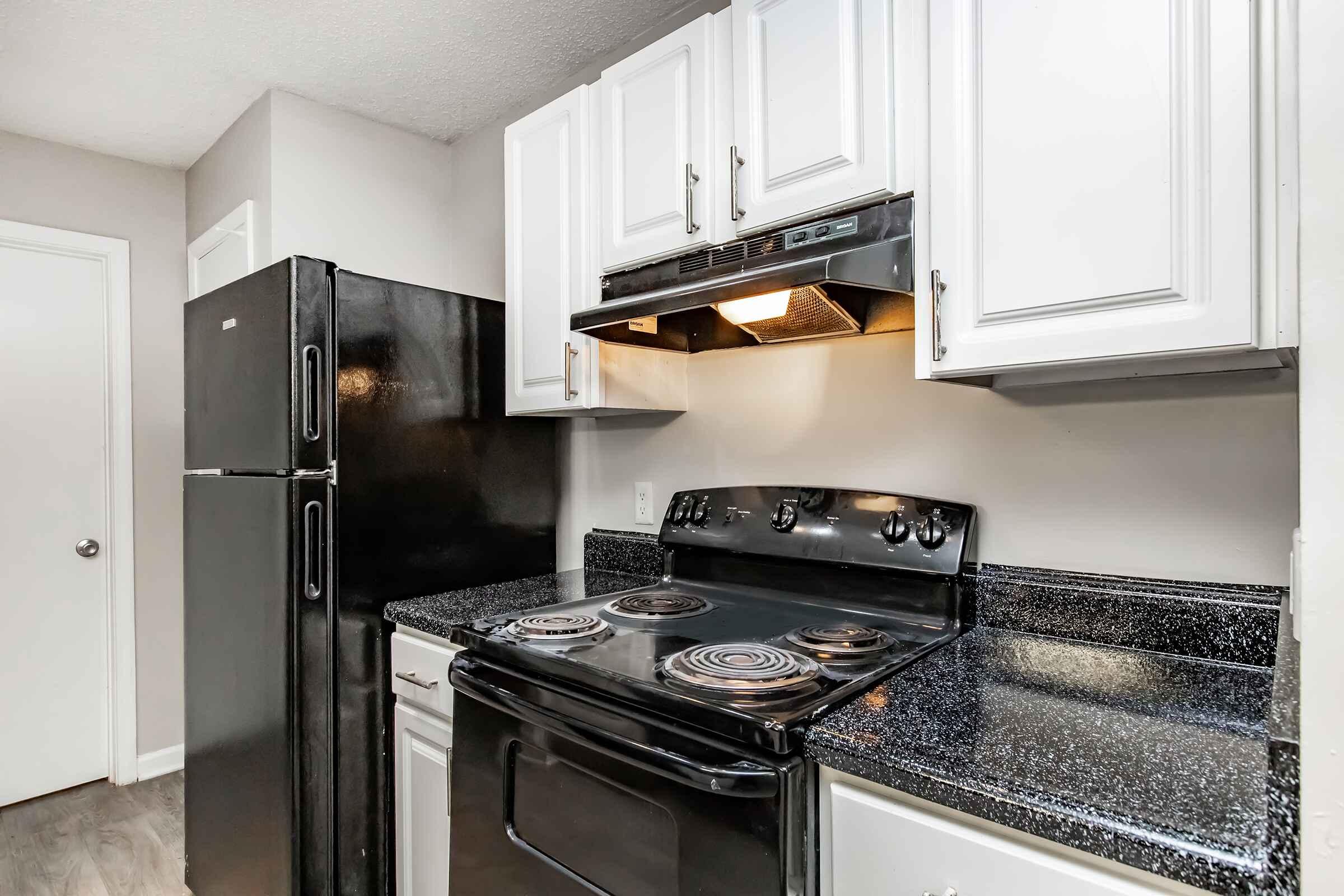 a stove top oven sitting inside of a kitchen