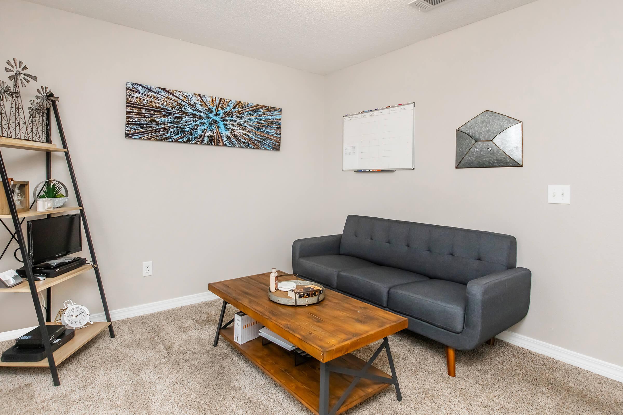 a living room filled with furniture and a flat screen tv