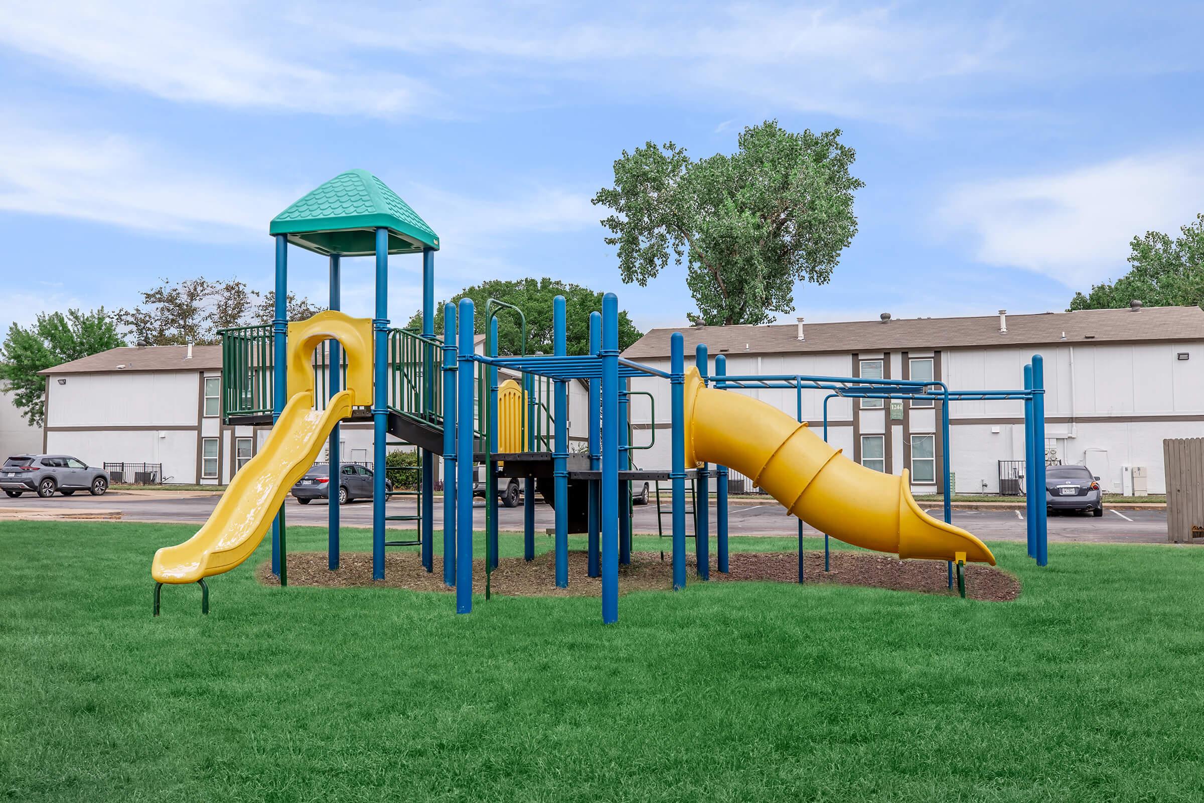 a large lawn in front of a playground