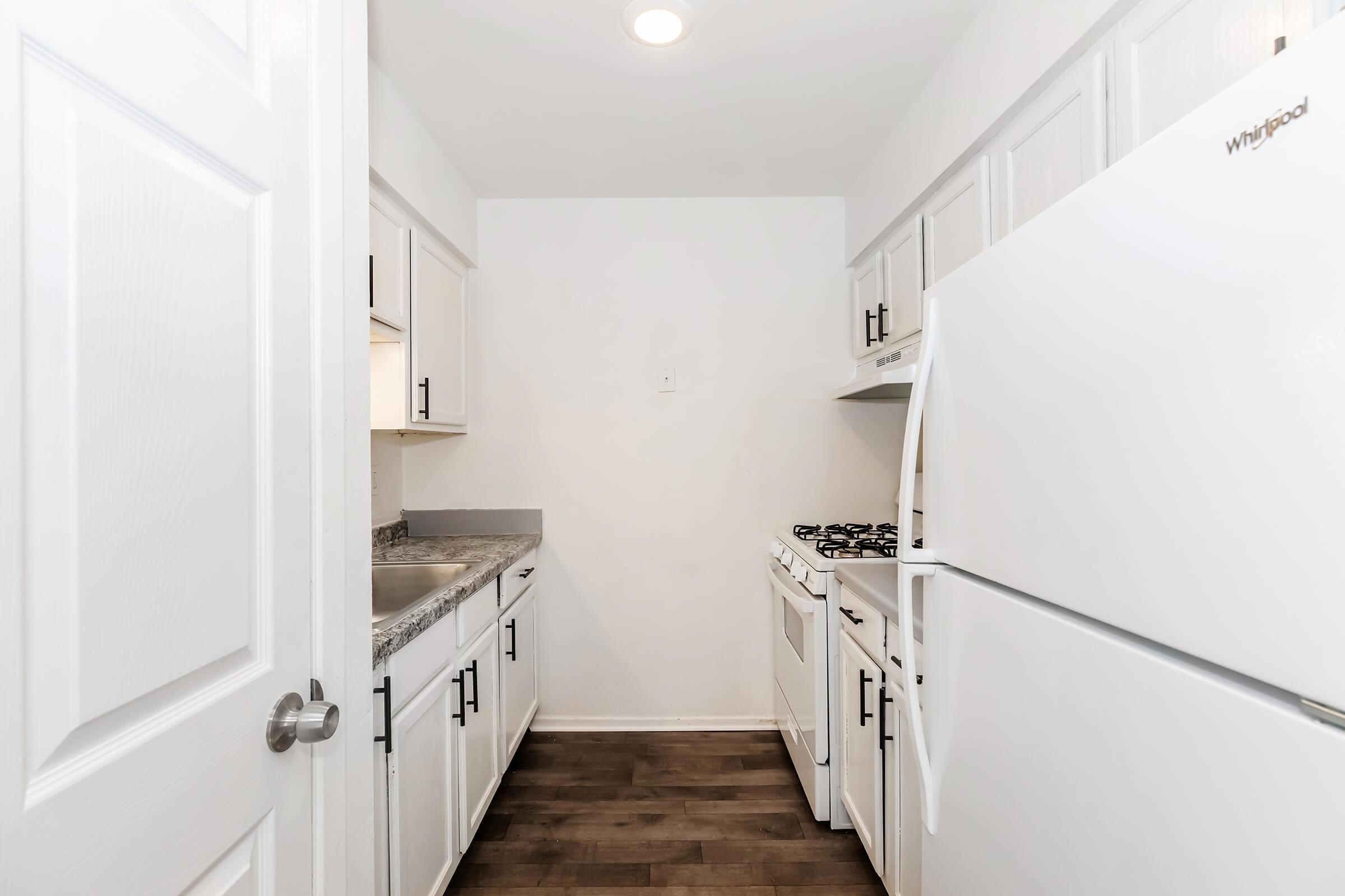 a kitchen with a sink and a refrigerator