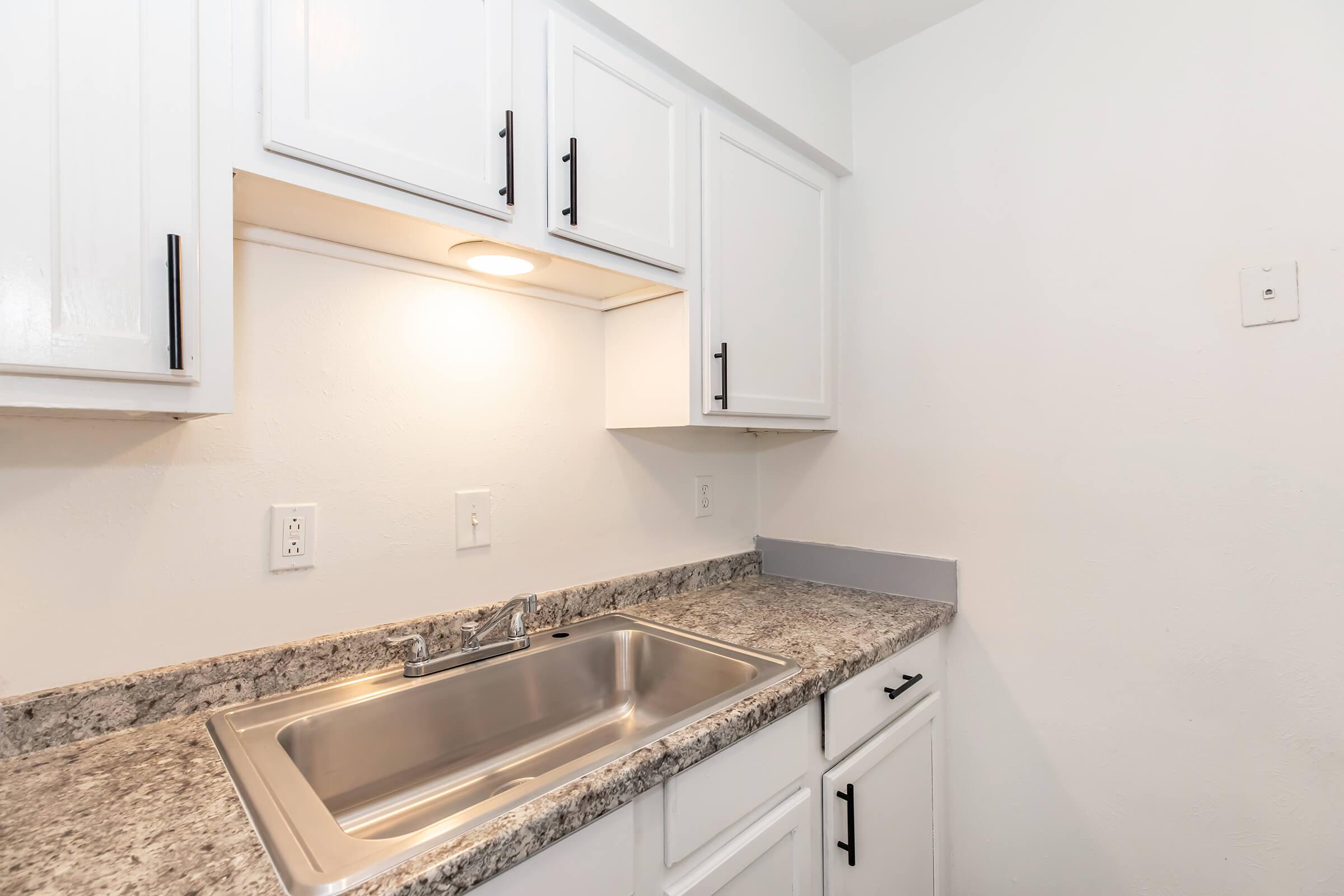 a kitchen with a sink and a microwave