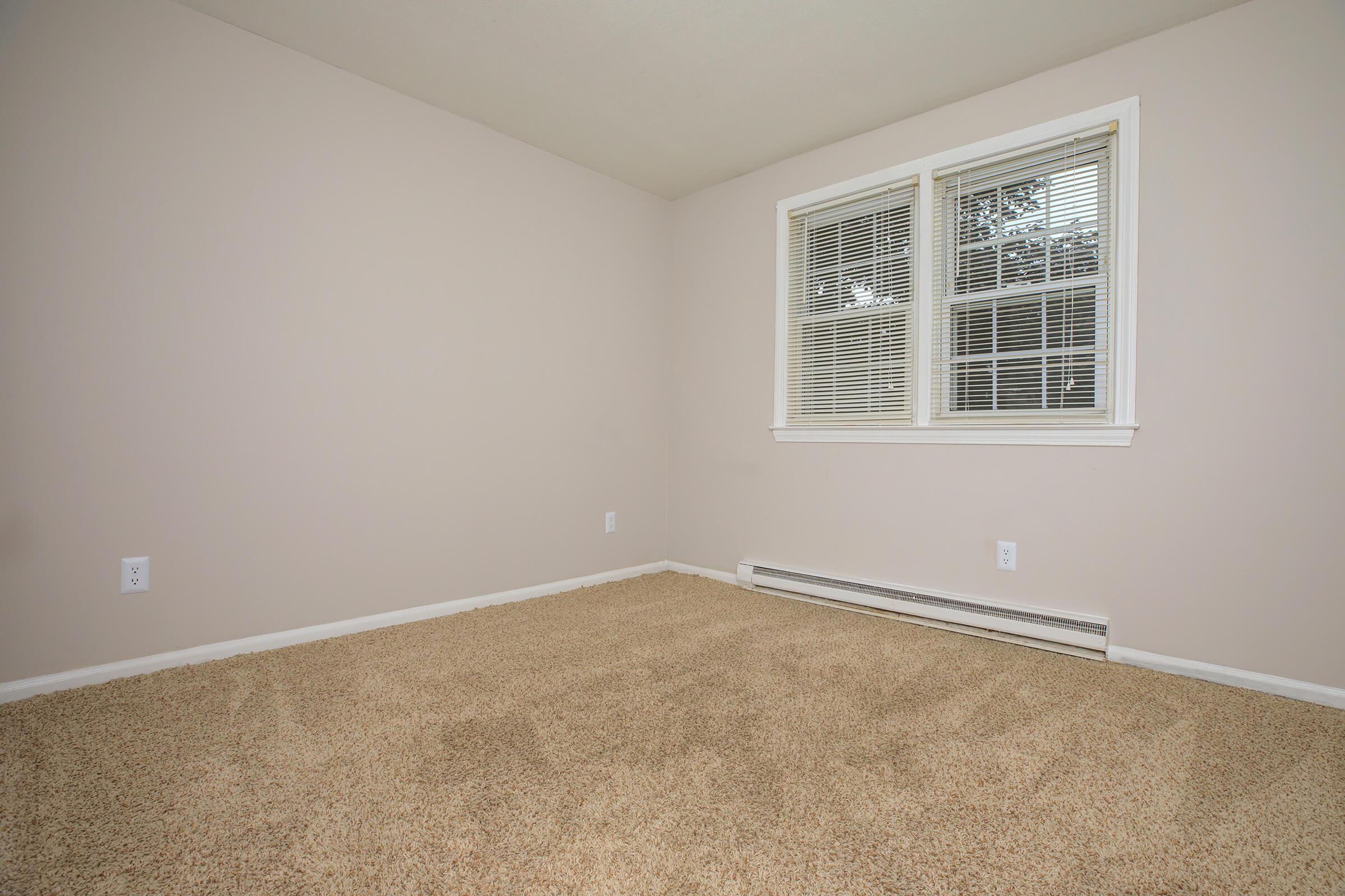 a bedroom with a large window