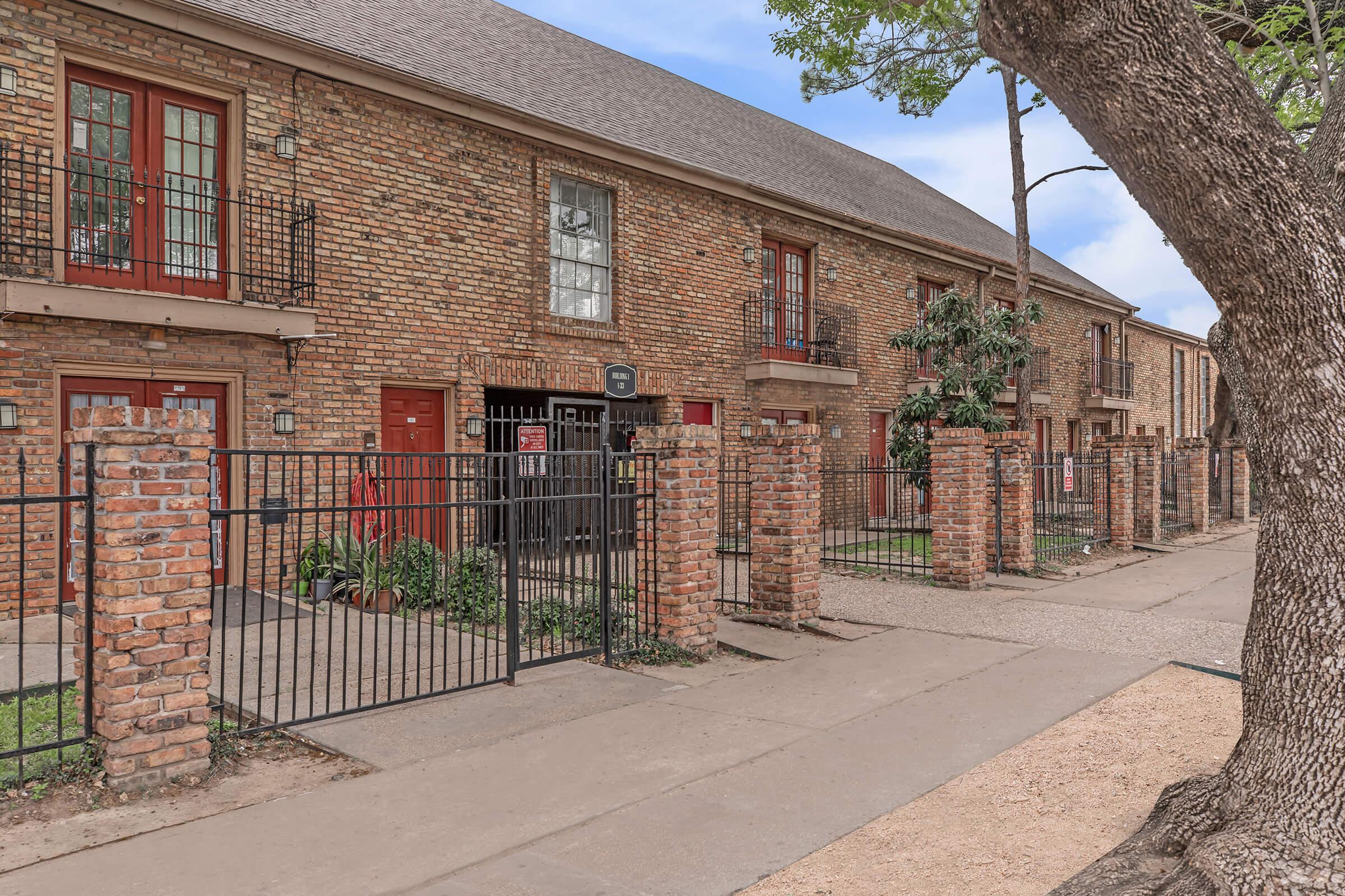 a stone path in front of a brick building