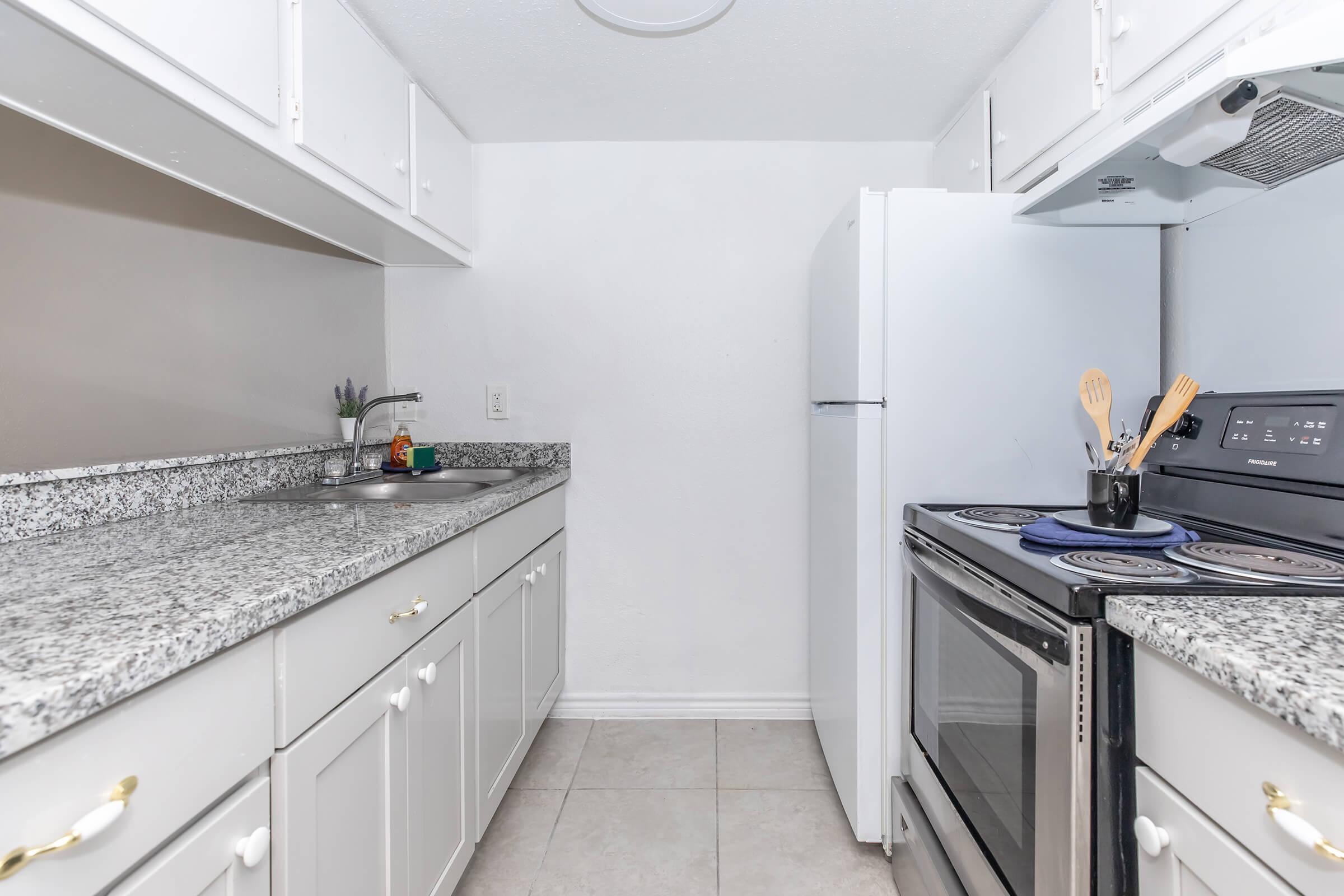 a kitchen with a stove and a sink