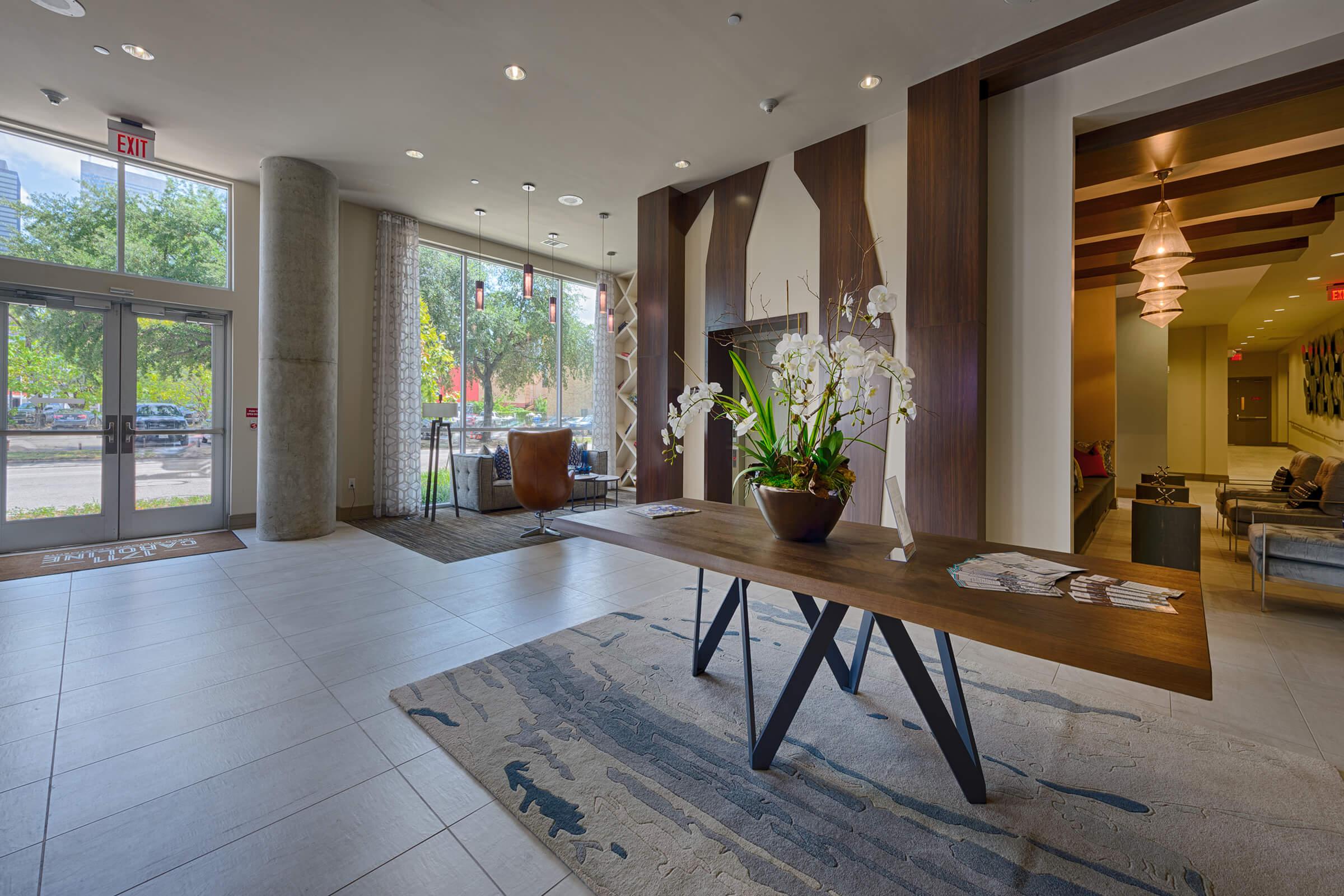 a living room filled with furniture and a large window
