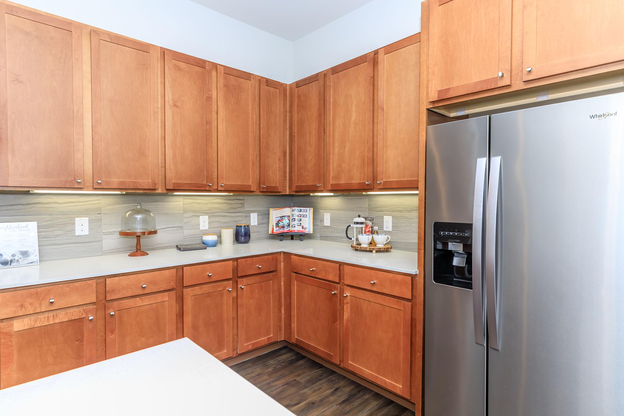 a kitchen with stainless steel appliances and wooden cabinets