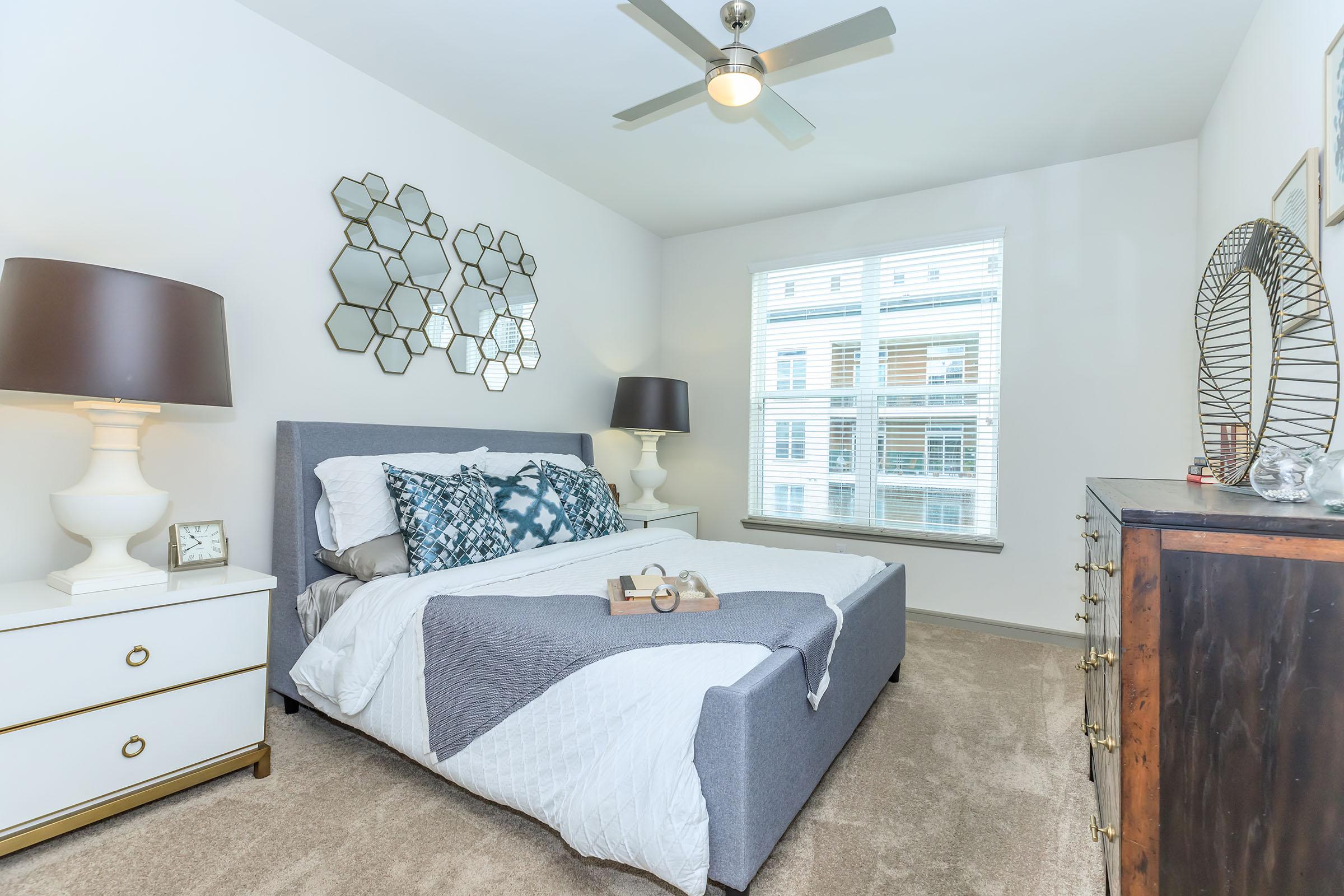 a bedroom with a large mirror