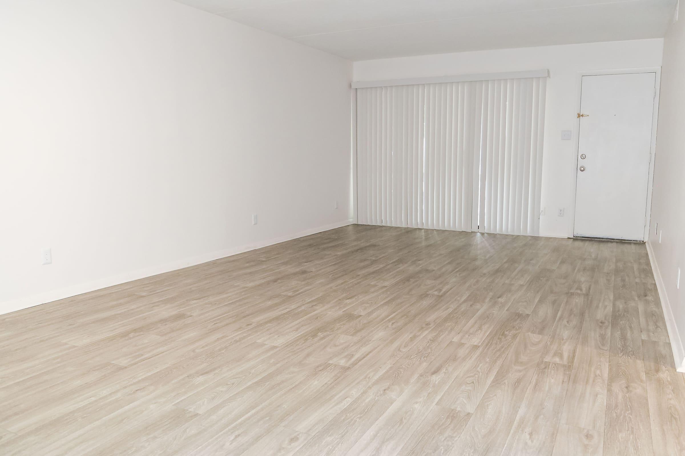 a bedroom with a wooden floor