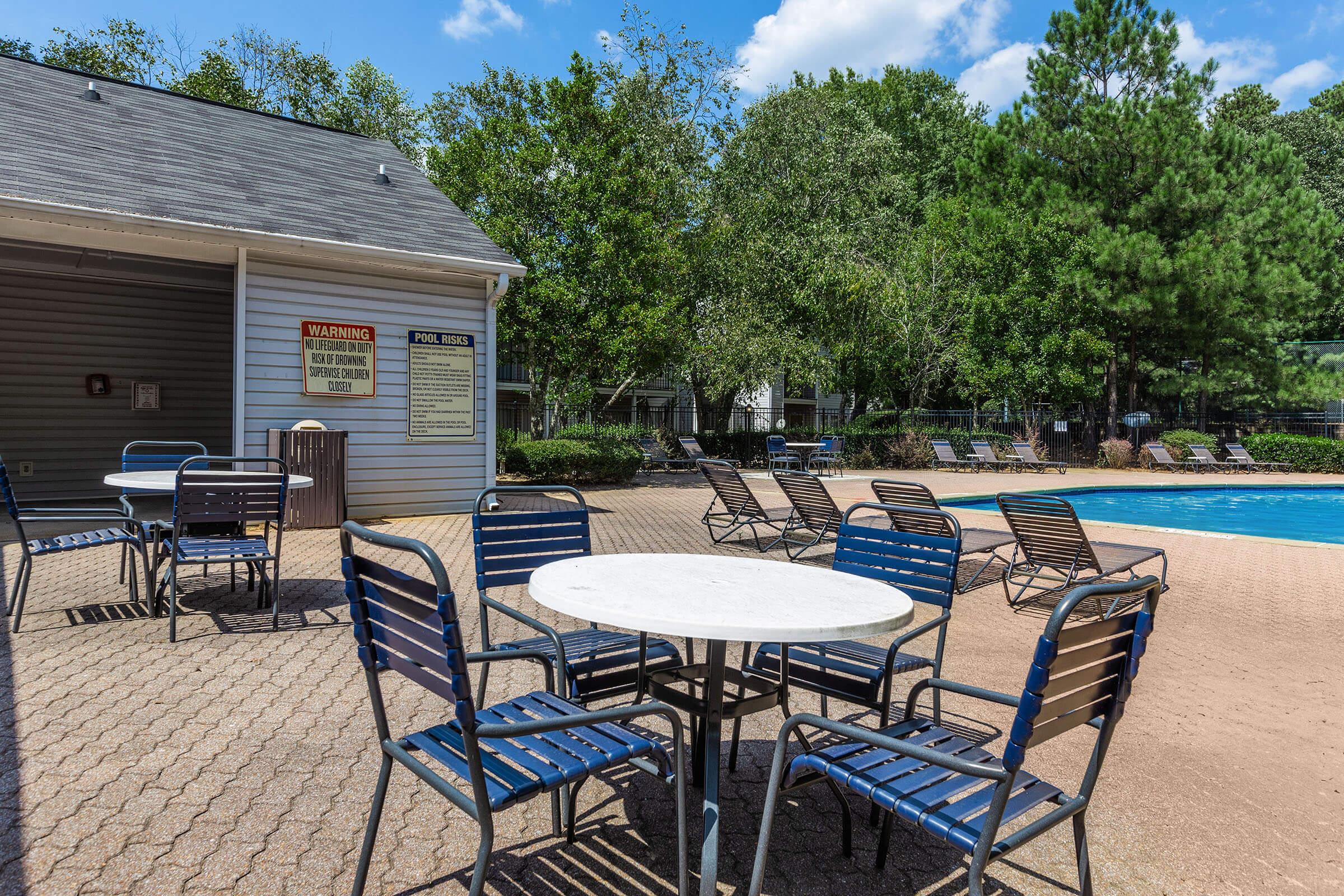 a group of lawn chairs sitting on top of a picnic table