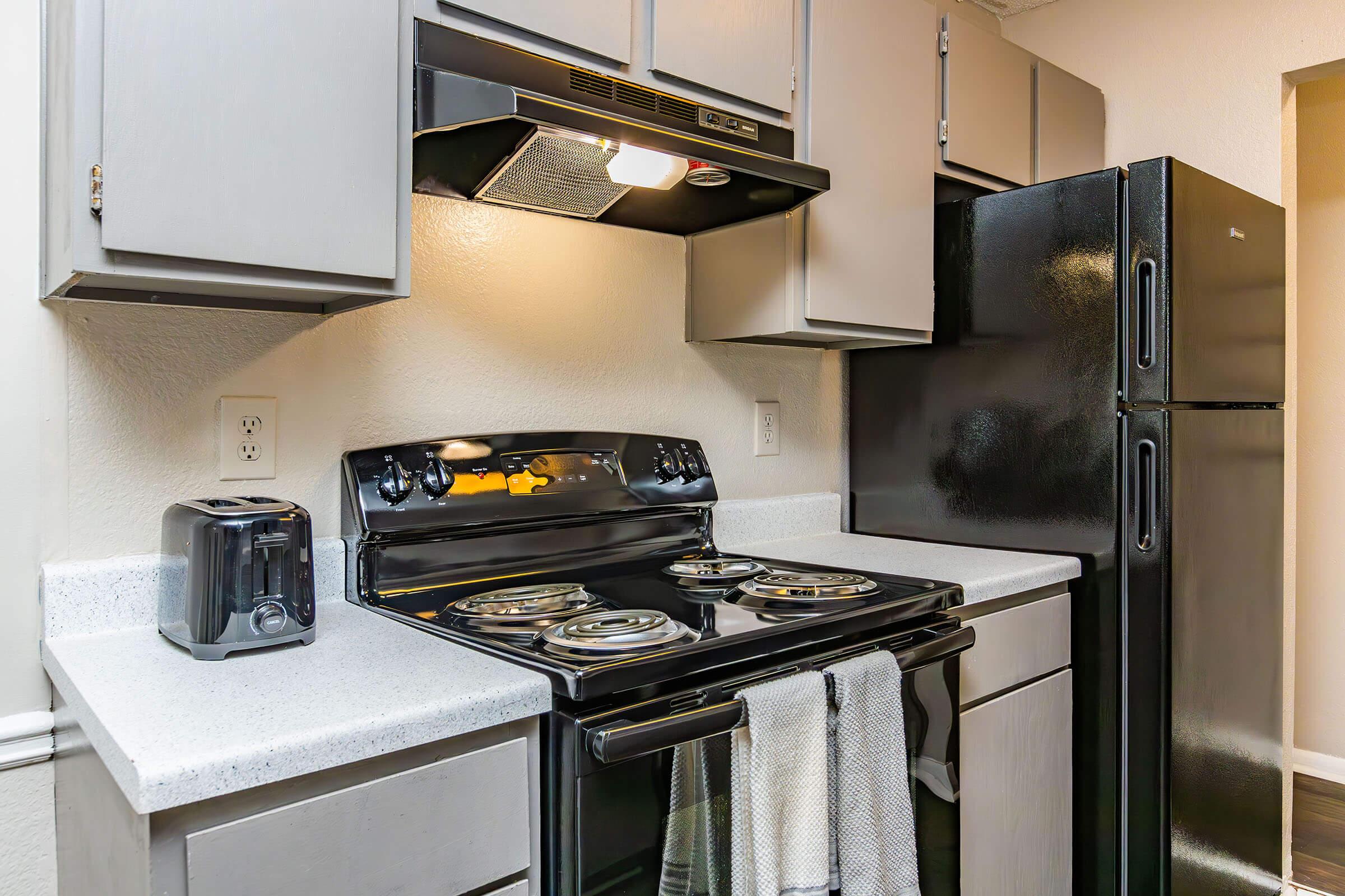 a stove top oven sitting inside of a kitchen