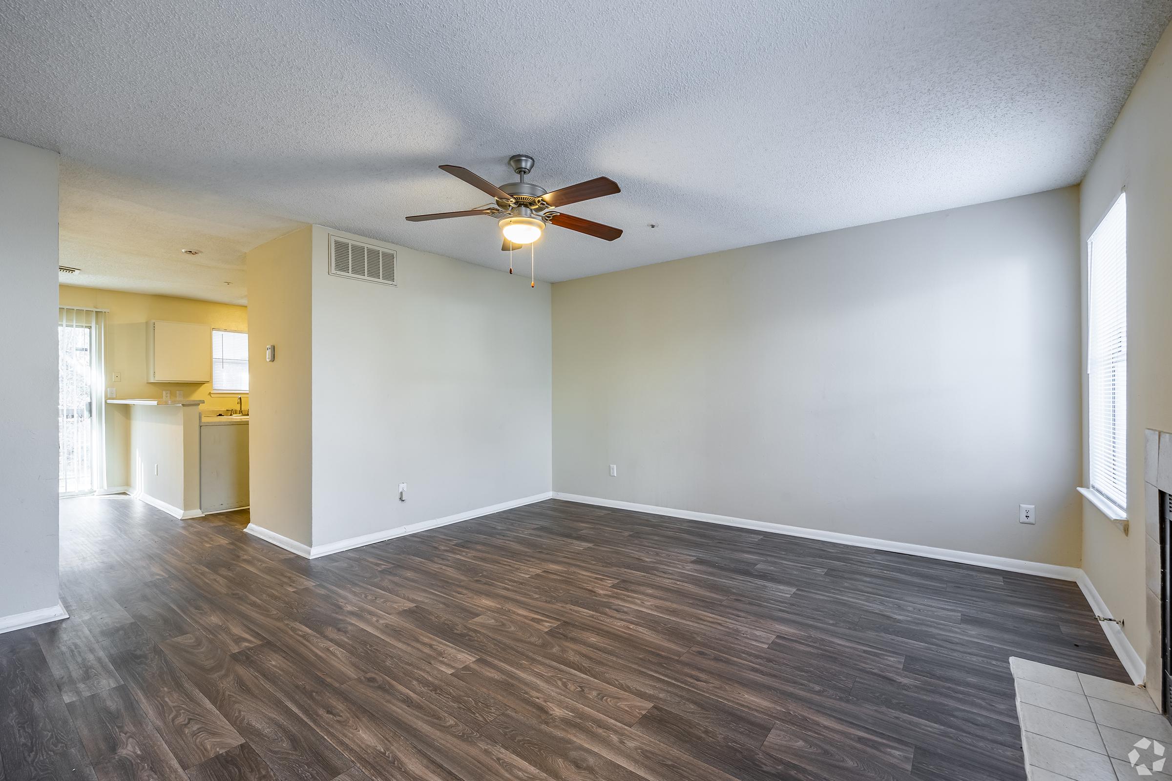 a large empty room with a wooden floor