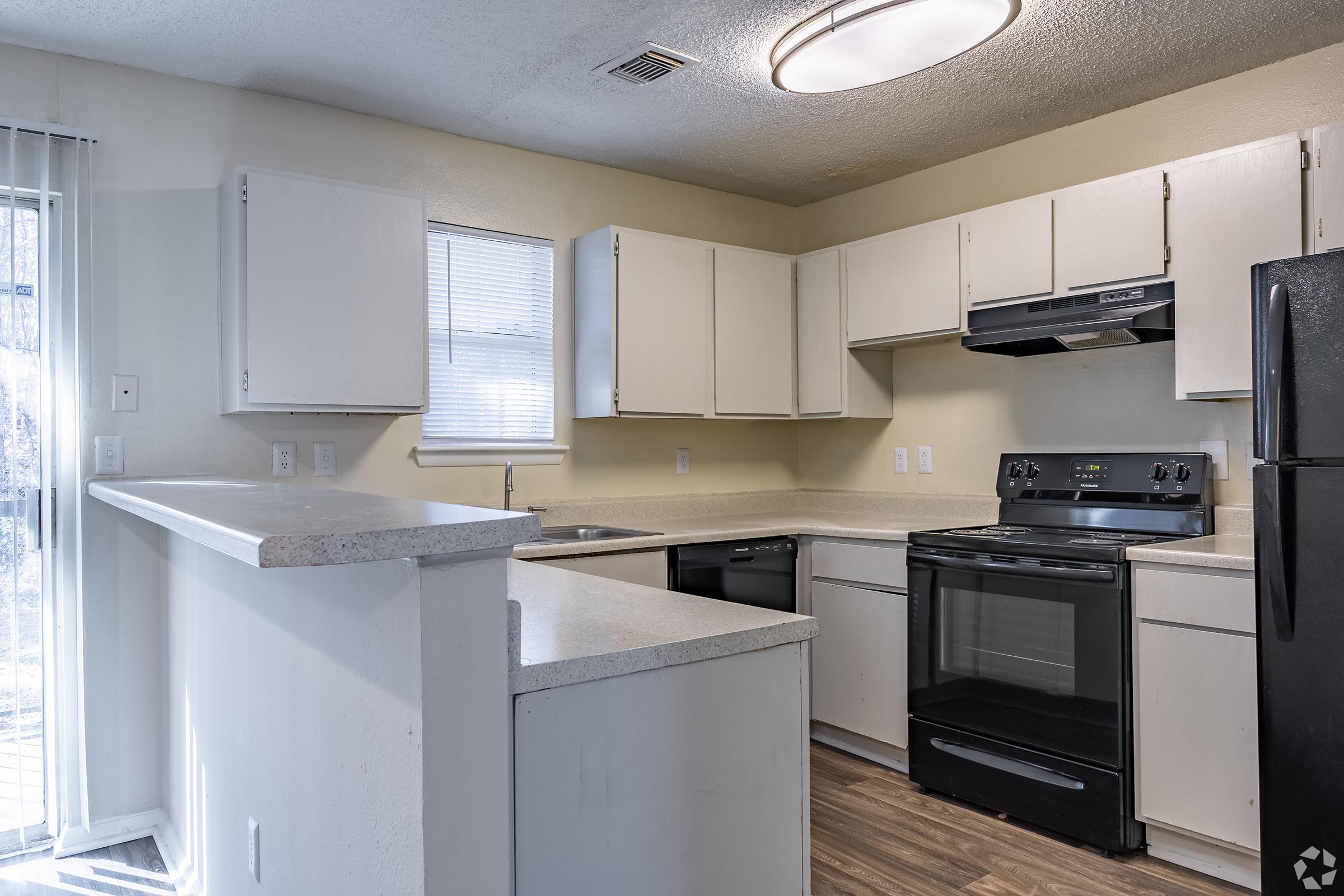 a kitchen with a stove and a refrigerator