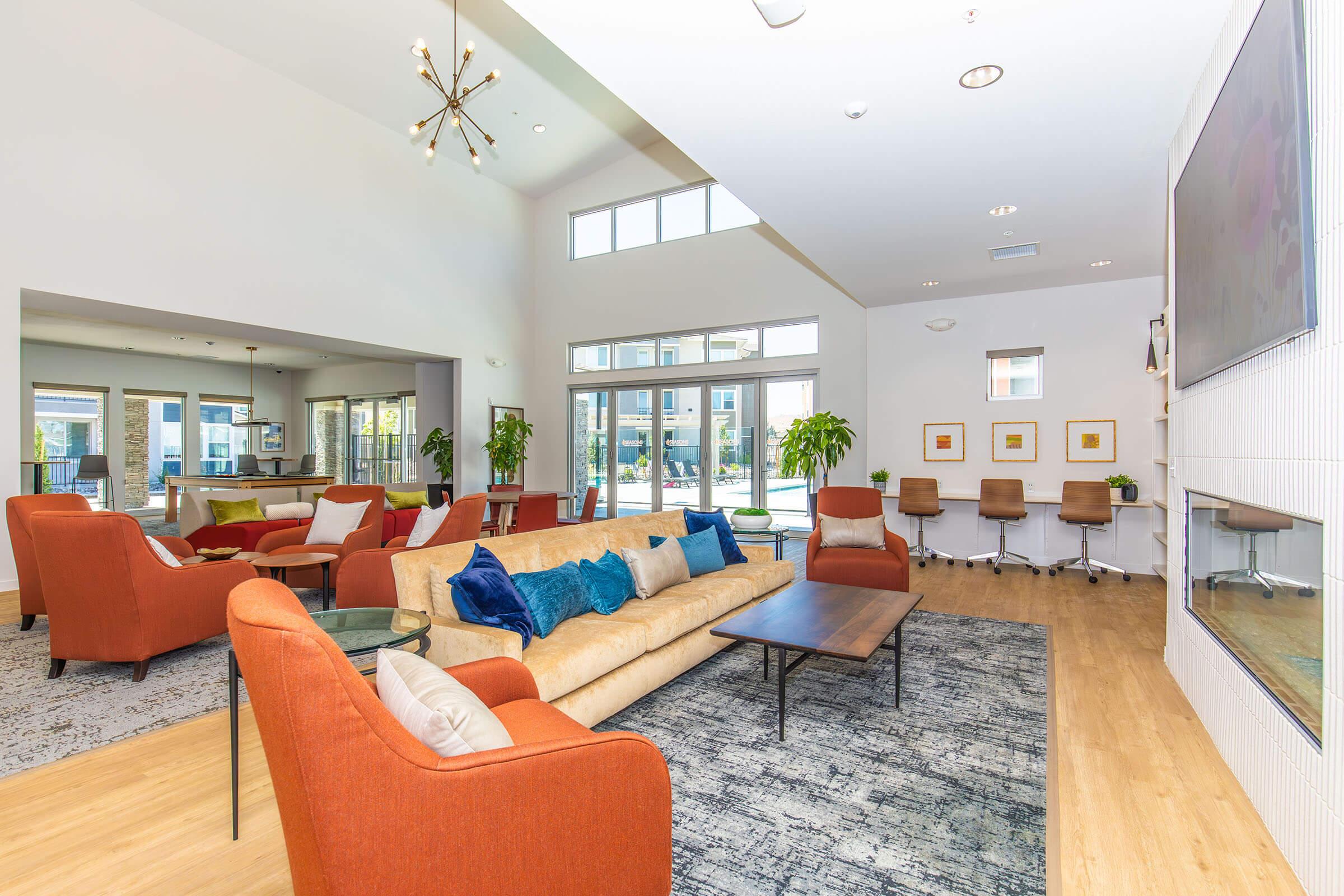 a view of a living room filled with furniture and a large window