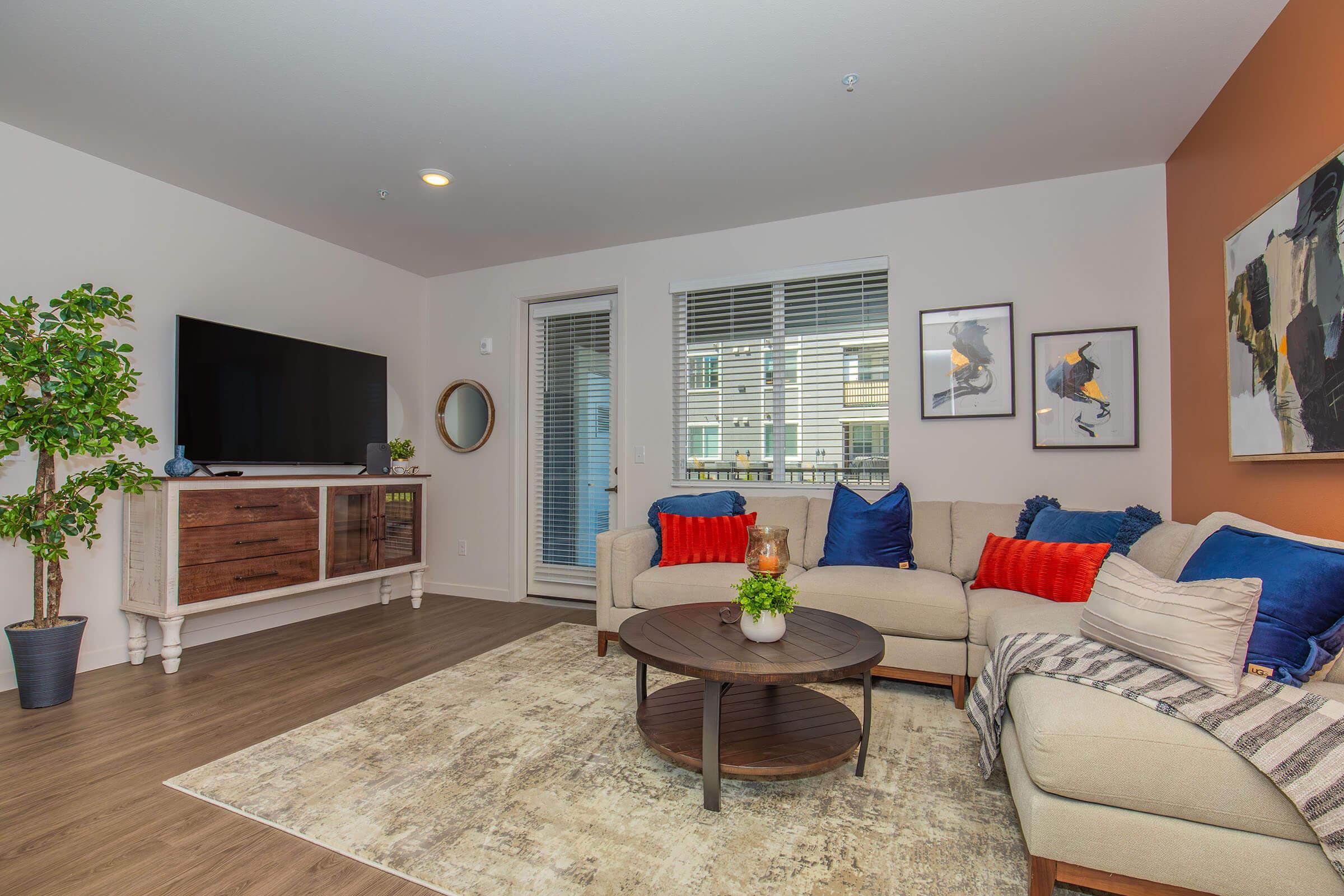 a living room filled with furniture and a flat screen tv