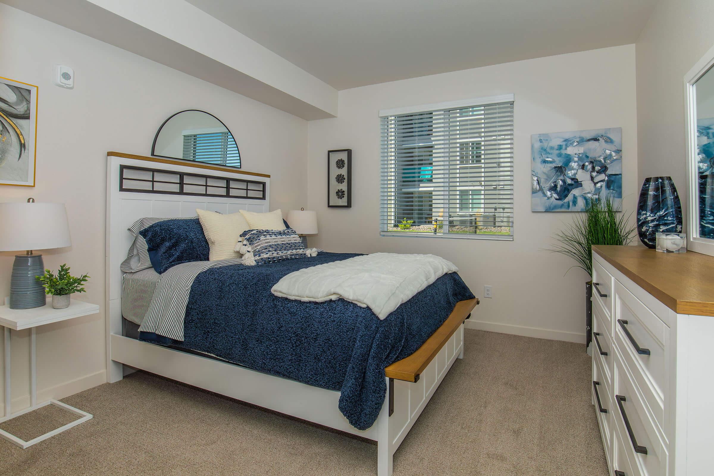 a living room with a bed and a window