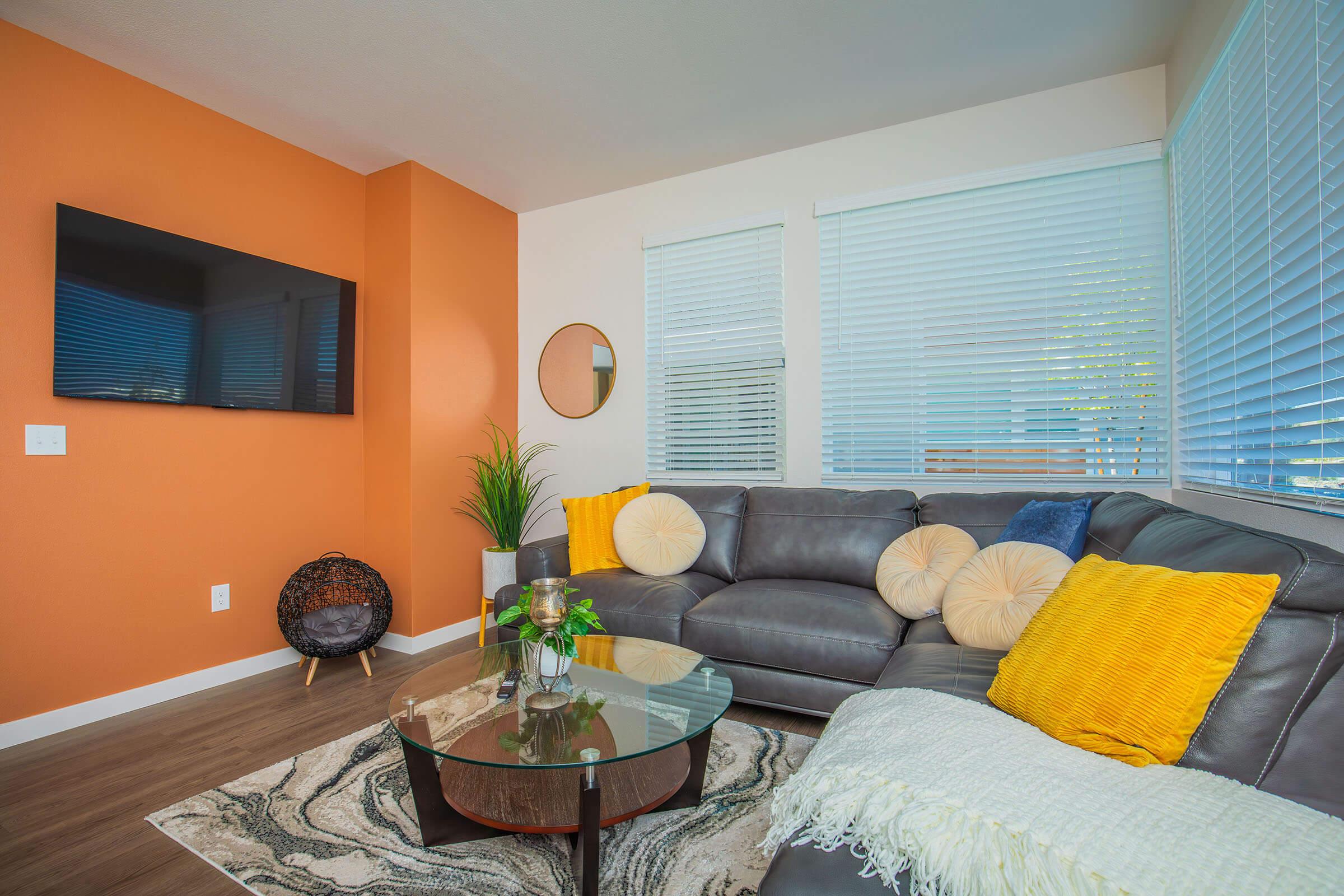 a living room filled with furniture and a large window