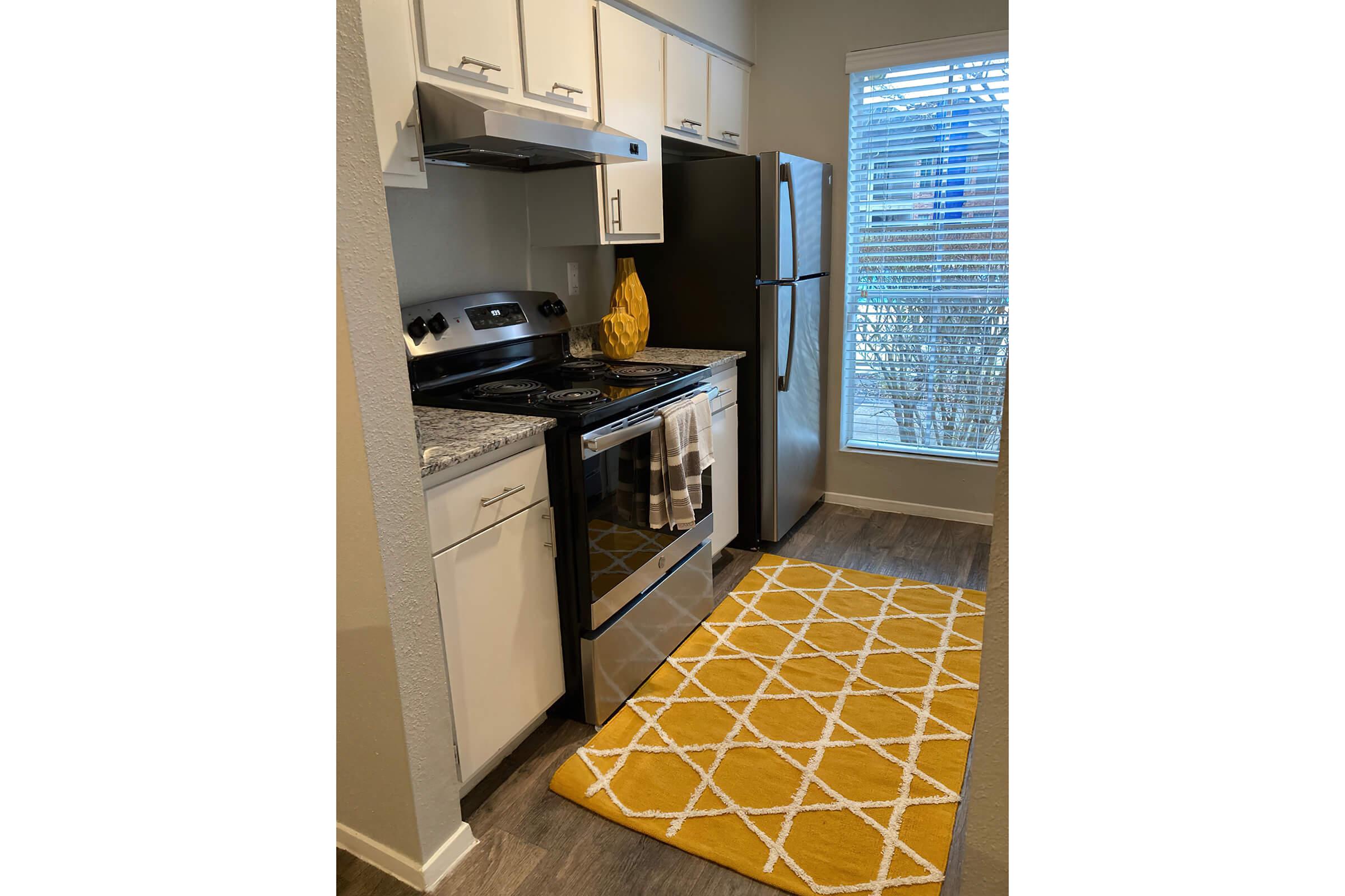 a stove top oven sitting inside of a kitchen