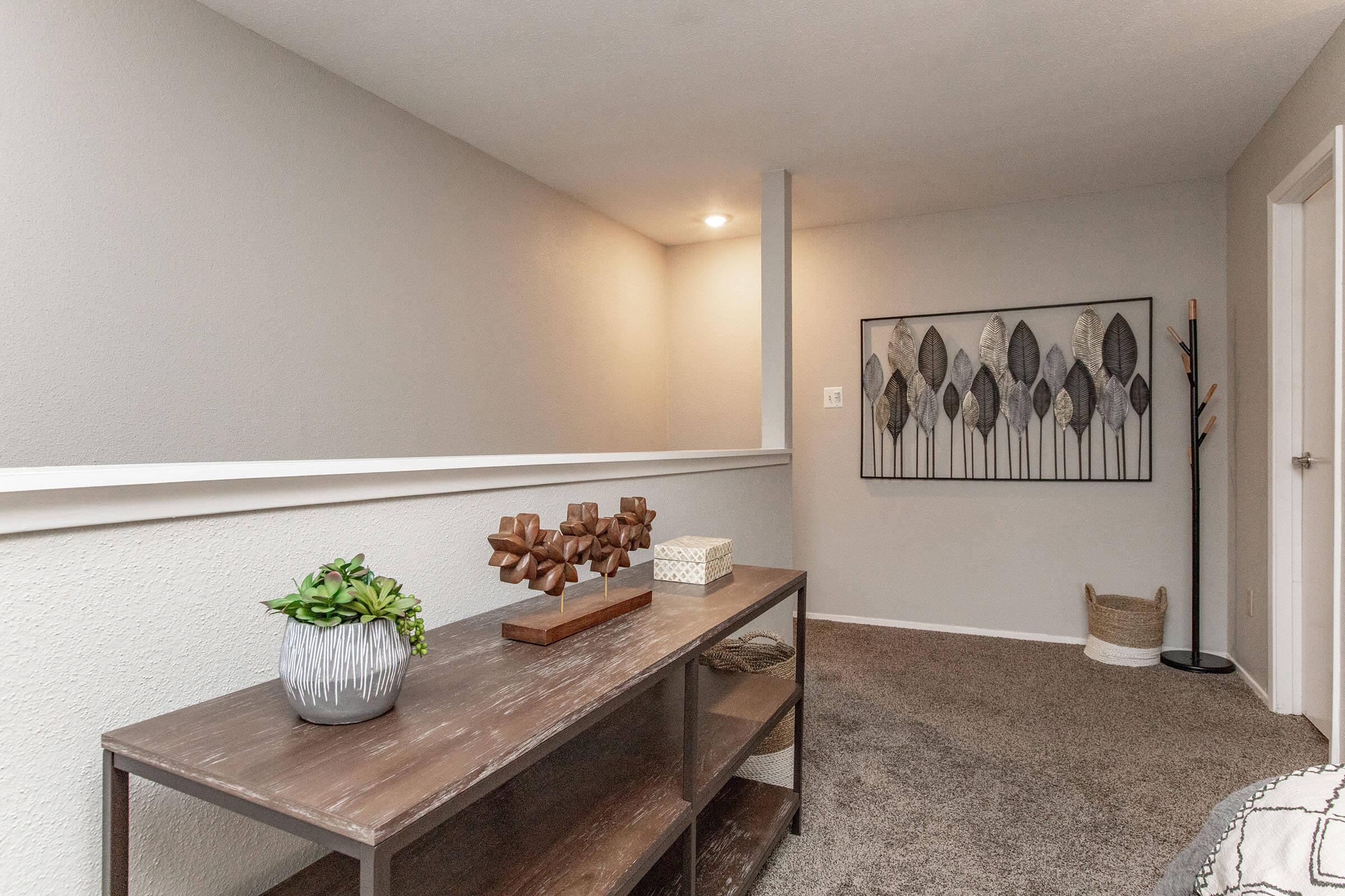 a room filled with furniture and vase of flowers on a table