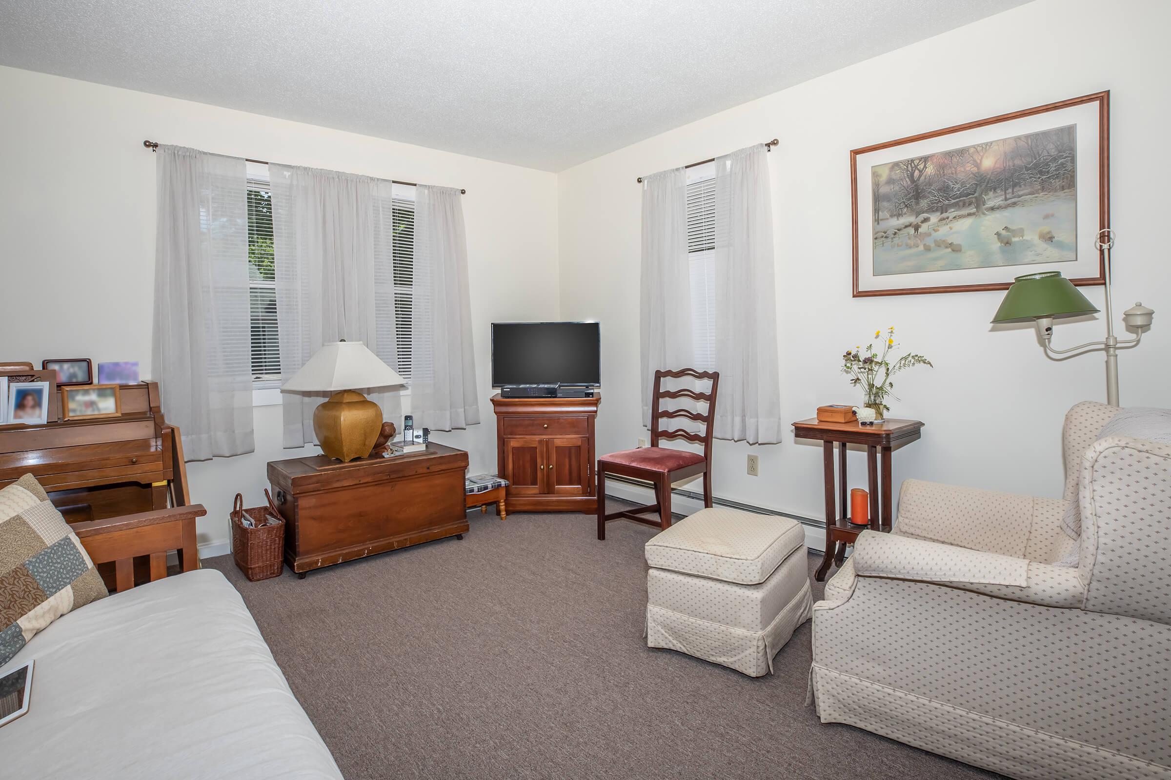 a bedroom with a bed and desk in a room