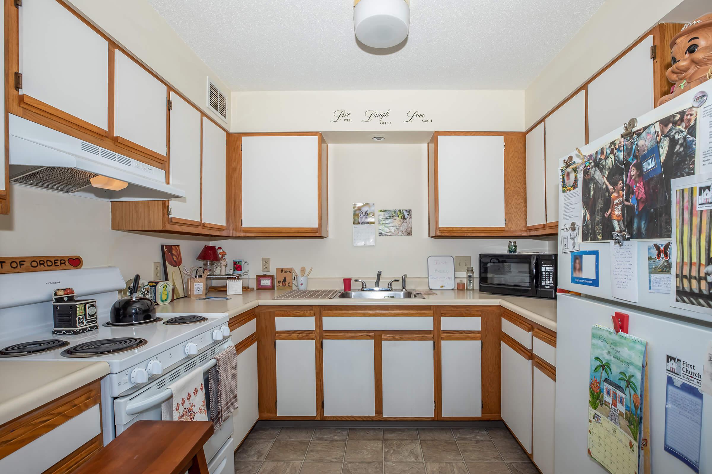 a kitchen with stainless steel appliances and wooden cabinets