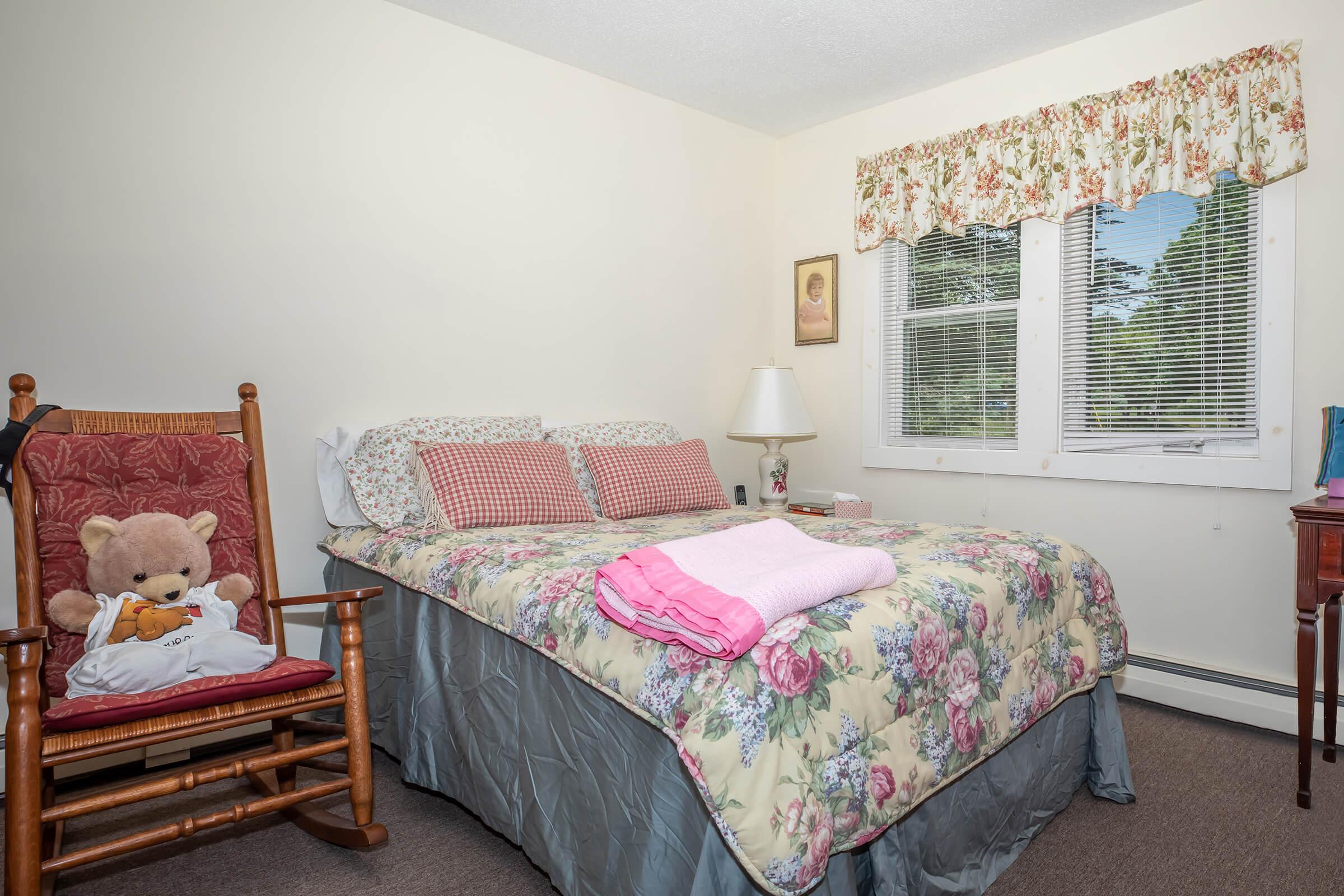 a living room filled with furniture and a bed in a bedroom