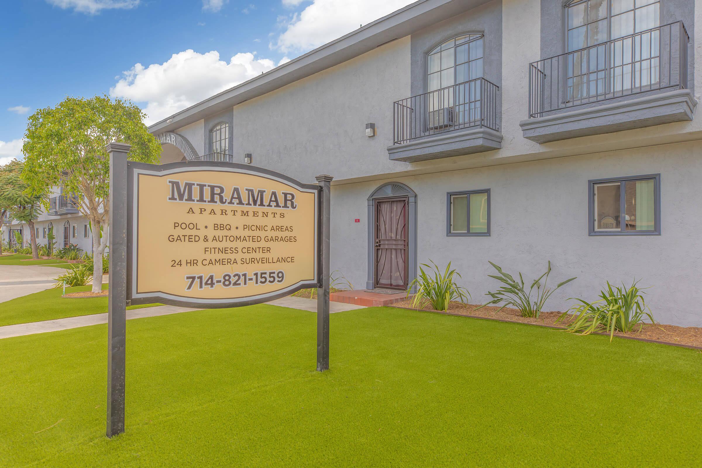 Miramar Apartments monument sign with green grass