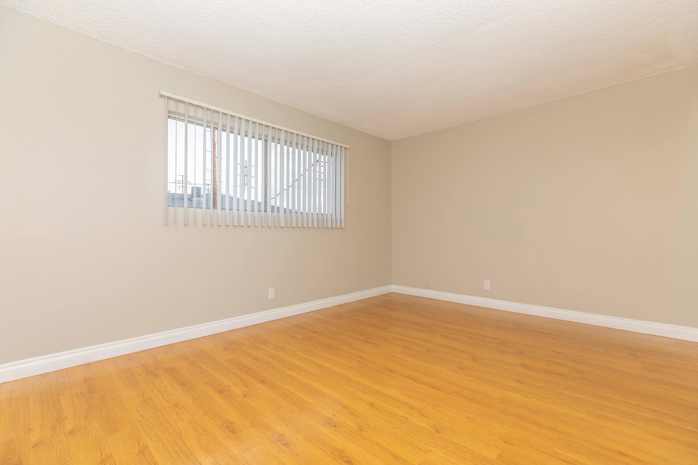 Vacant bedroom with wooden floors