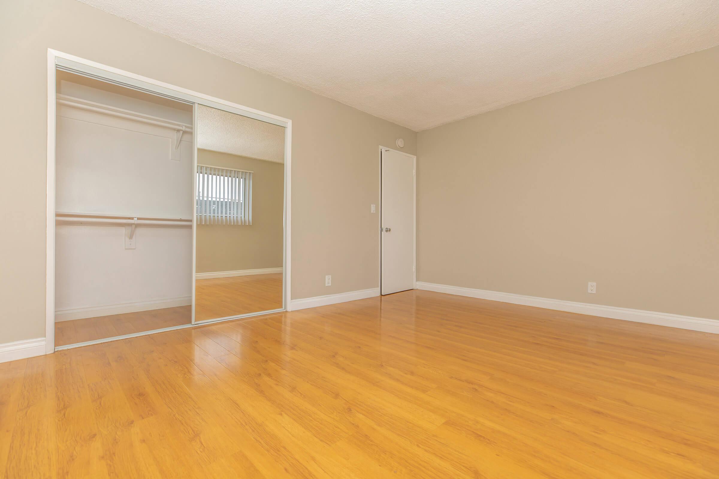 Bedroom with open sliding mirror closet door