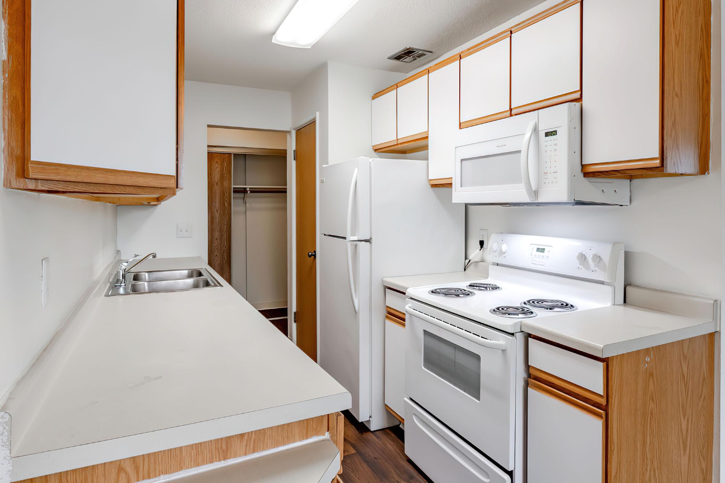 a kitchen with a sink and a microwave