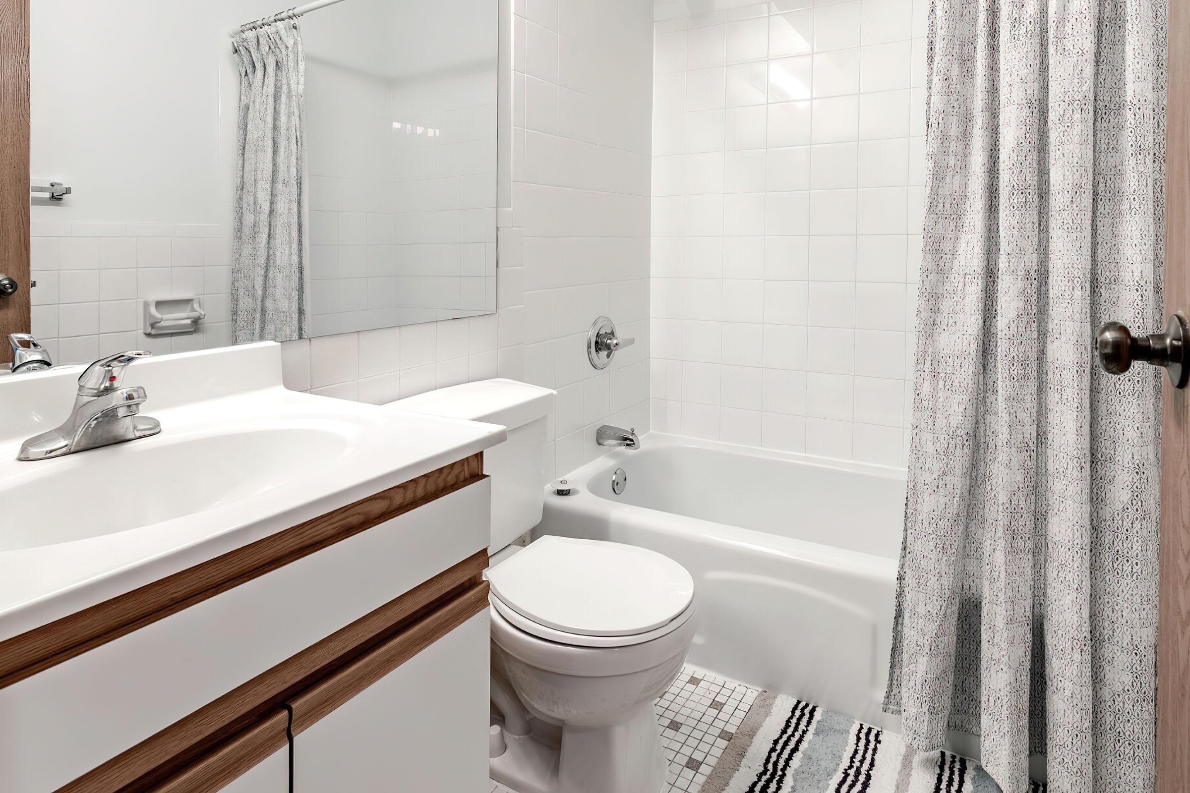 a shower curtain next to a sink