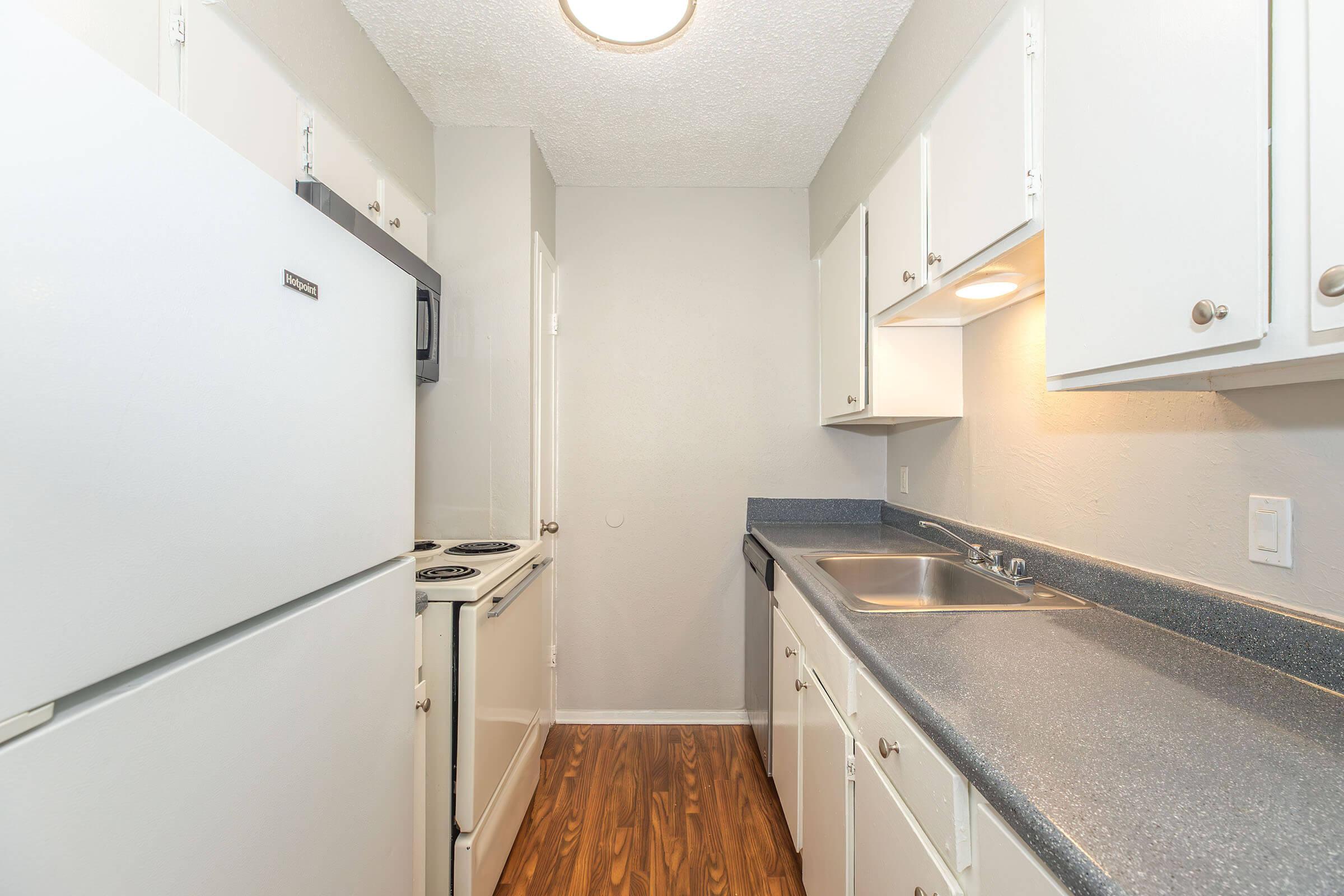 a kitchen with a sink and a refrigerator